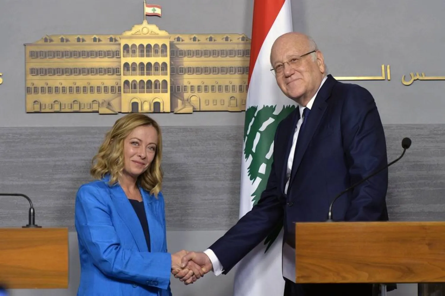 Lebanese caretaker Prime Minister Najib Mikati (R) shakes hands with Italian Prime Minister Giorgia Meloni (L) following a joint press conference at the government palace in Beirut, Lebanon, 18 October 2024. (EPA)