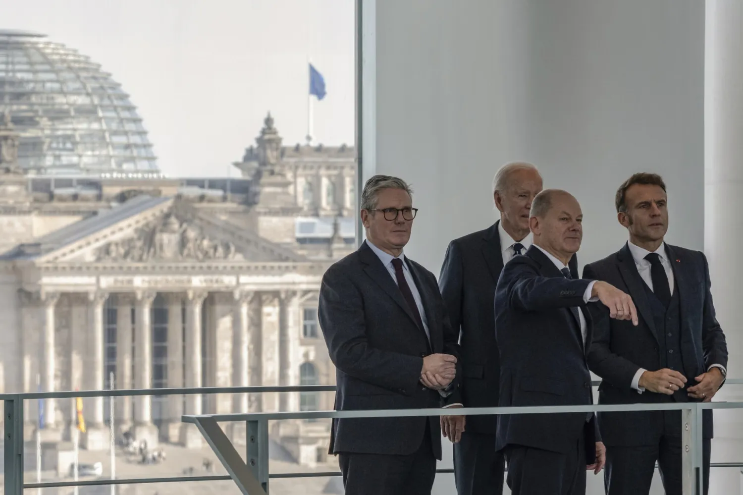German Chancellor Olaf Scholz, front, gestures as he speaks with British Prime Minister Keir Starmer, left, US President Joe Biden and French President Emmanuel Macron, right, before their Quad meeting at the Chancellery in Berlin, Germany, Friday Oct. 18, 2024. (John Macdougall/Pool Photo via AP) 
