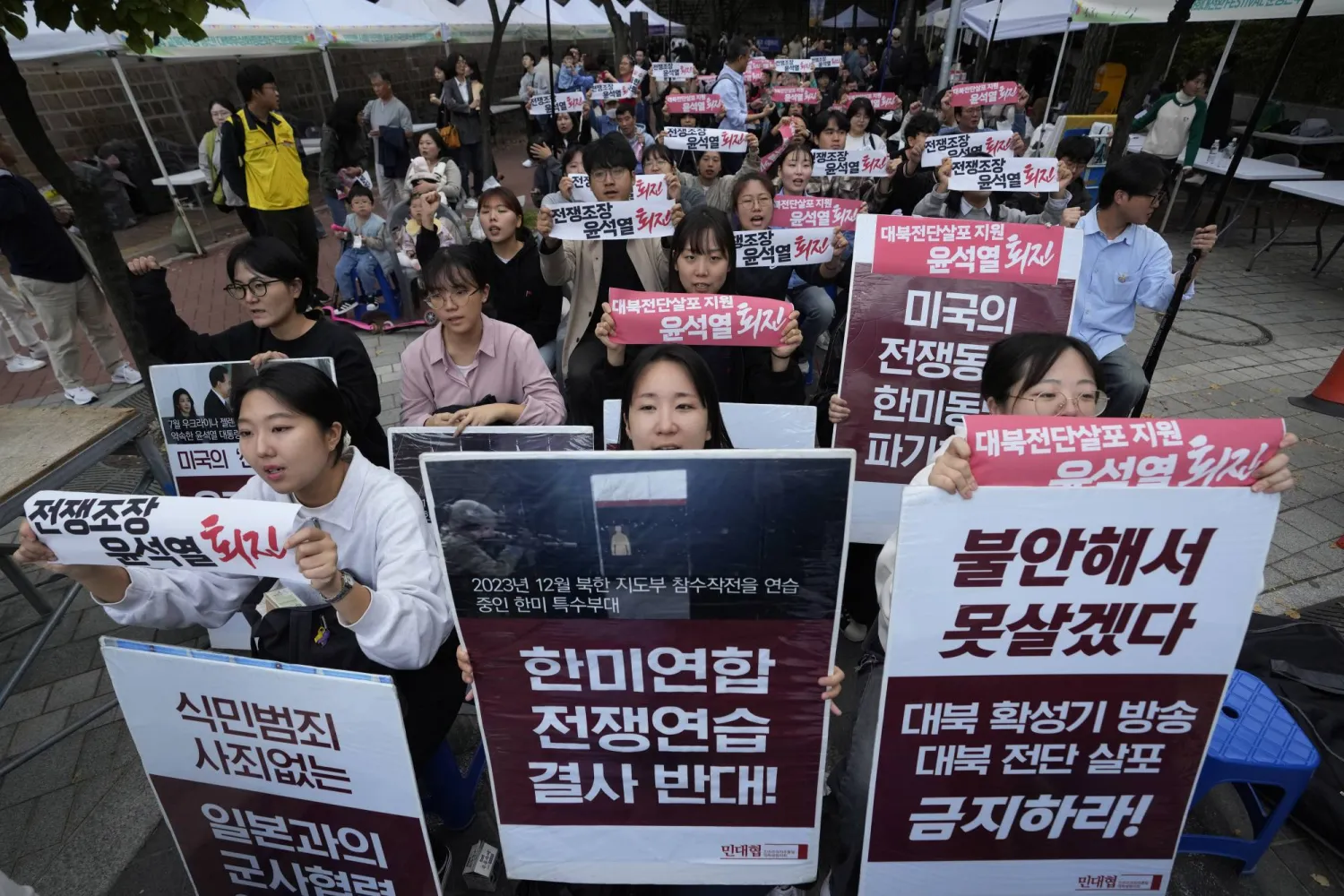 South Korean protesters stage a rally against flying of anti-North Korean propaganda leaflets into North Korea, in Seoul, South Korea, Saturday, Oct. 19, 2024. The banners read, "Opposition to South Korea-US joint war exercise." (AP Photo/Ahn Young-joon)