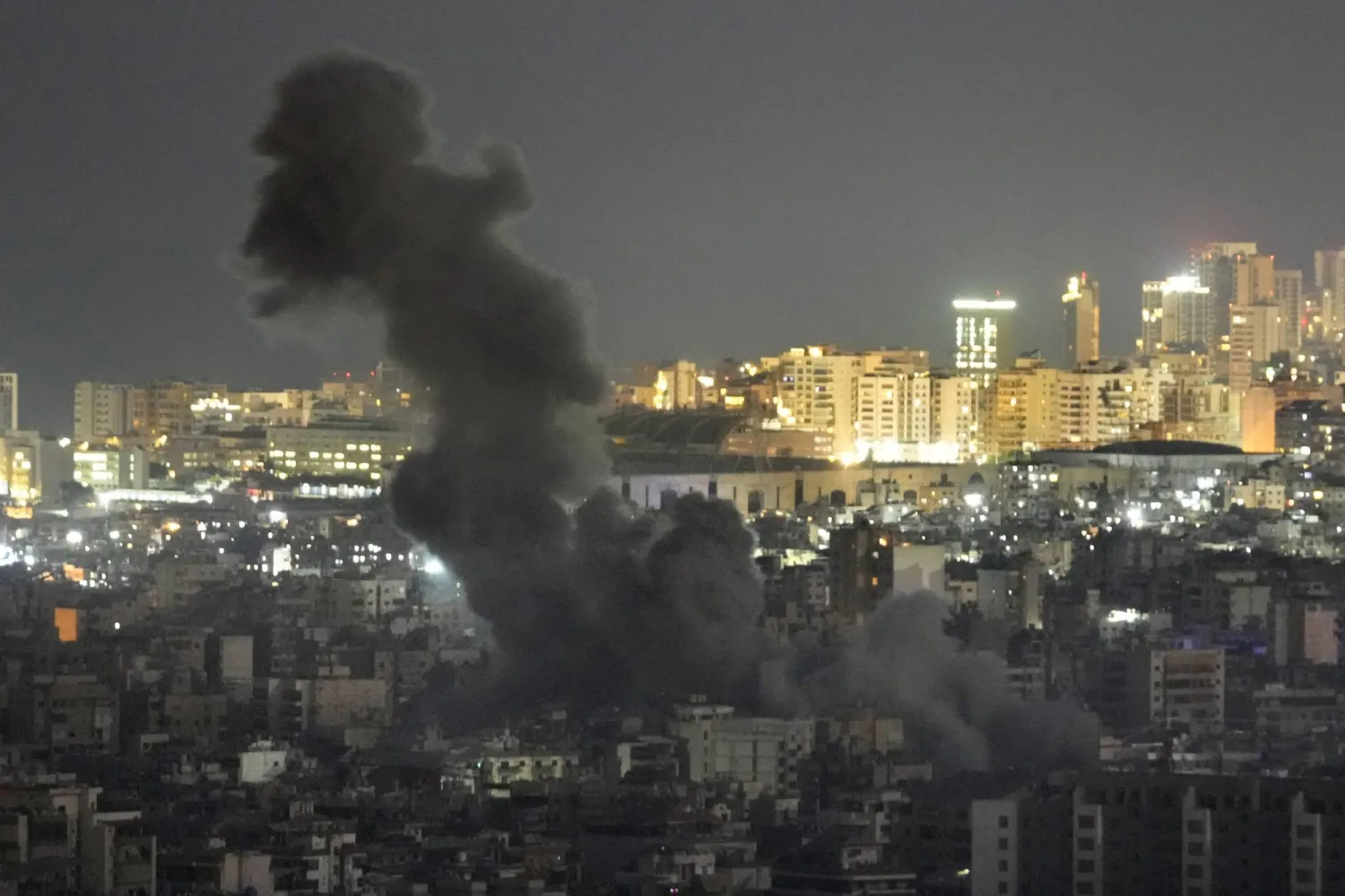 Smoke rise from an Israeli airstrike on Dahiyeh in the southern suburb of Beirut, as Beirut city seen in the background, Lebanon, Sunday, Oct. 20, 2024. (AP Photo/Hussein Malla)