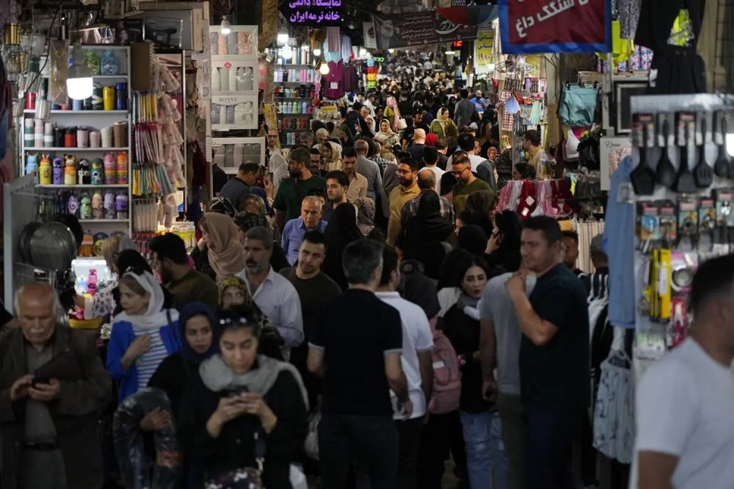 People walk through the old main bazaar of Tehran, Iran, Saturday, Oct. 19, 2024. (AP)