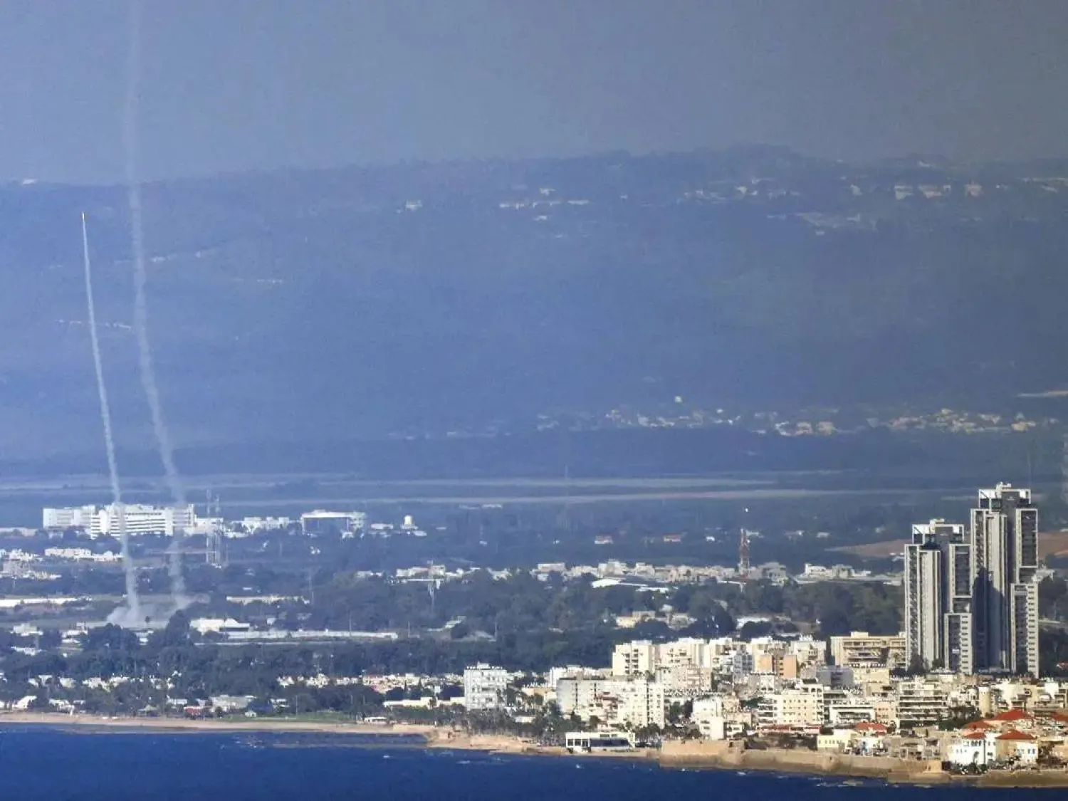 This picture taken from the northern Israeli port city of Haifa shows rockets fired from Israel's Iron Dome air defense system near the northern Israeli city of Acre during a rocket attack from Lebanon on October 12, 2024. (AFP) 