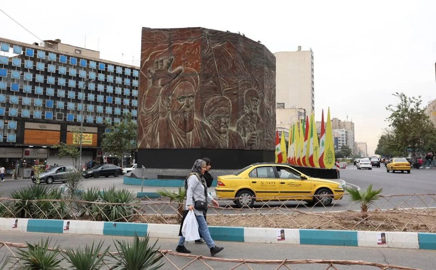 Iranians walk past the statue of former Iranian supreme leader Khomeini at the Enghelab Square in Tehran, Iran, 21 October 2024. (EPA) 