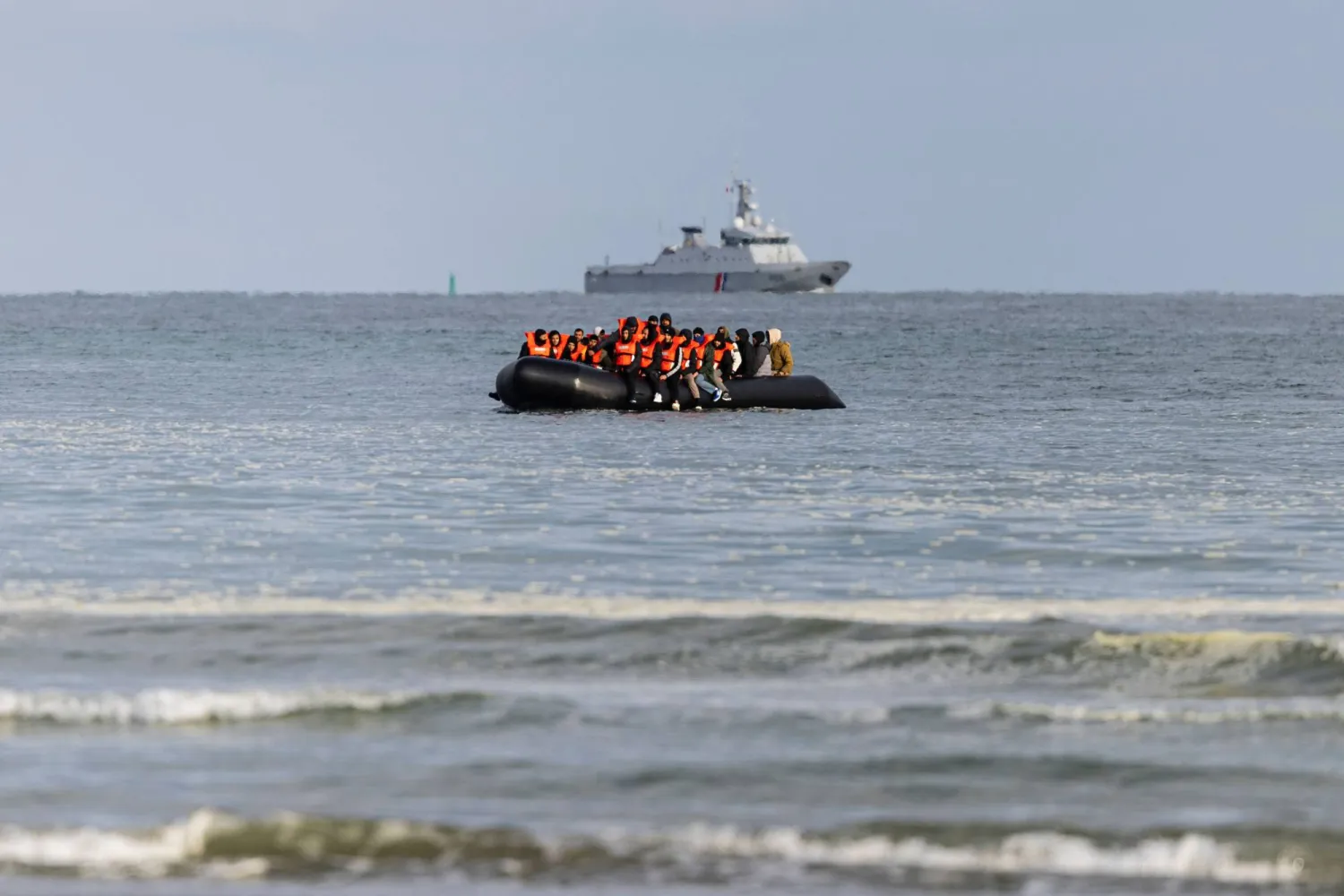 (FILES) Migrants board a smuggler's boat in an attempt to cross the English Channel, on the beach of Gravelines, near Dunkirk, northern France on April 26, 2024. (Photo by Sameer Al-DOUMY / AFP)