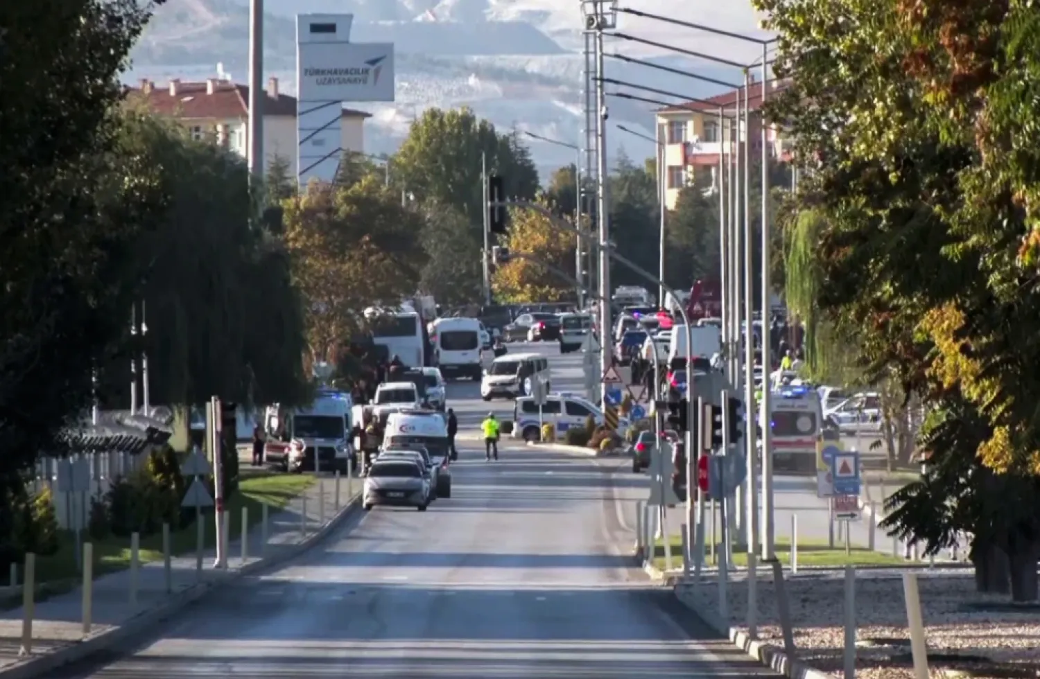 Emergency rescue teams and police officers work outside of Turkish Aerospace Industries Inc. on the outskirts of Ankara, Türkiye, Wednesday, Oct. 23, 2024. (IHA via AP)

