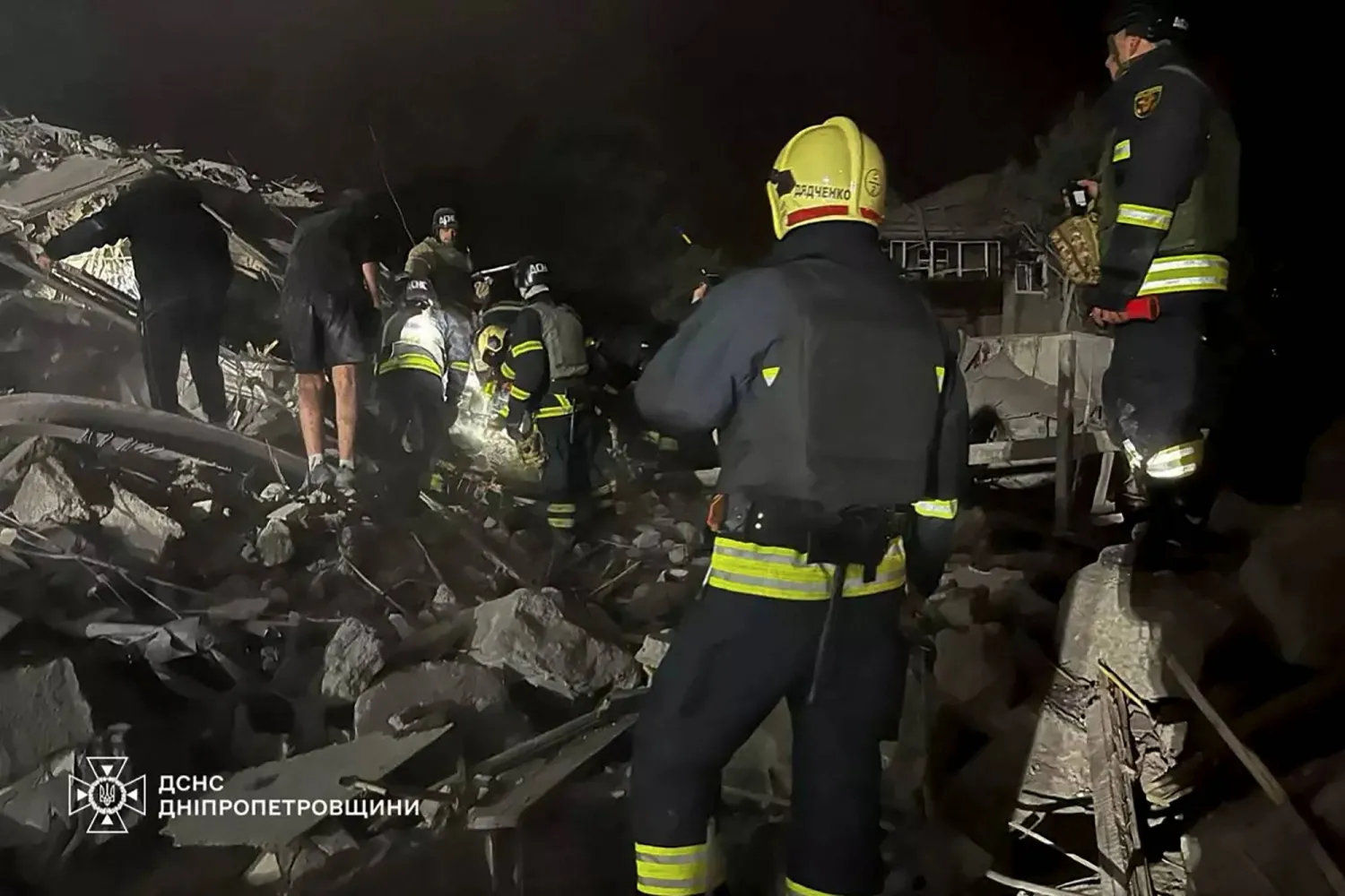 This undated handout photograph released by the Ukrainian Emergency Service on October 26, 2024, shows rescuers working on the site of a Russian air attack in Dnipro, eastern Ukraine, amid the Russian invasion of Ukraine. (Photo by Handout / UKRAINIAN EMERGENCY SERVICE / AFP)