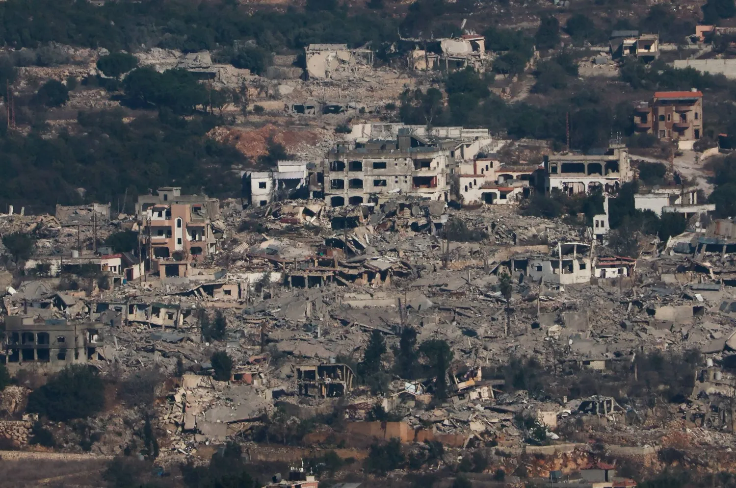 A view shows destroyed residential buildings in Rmeish in southern Lebanon, amid ongoing hostilities between Hezbollah and Israeli forces, as seen from Sasa, northern Israel, October 26, 2024. REUTERS/Gonzalo Fuentes