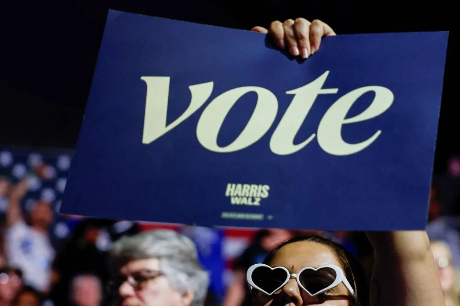  A supporter holds a placard during a campaign event for Democratic presidential nominee US Vice President Kamala Harris at Wings Event Center in Kalamazoo, Michigan, October 26, 2024. (Reuters)