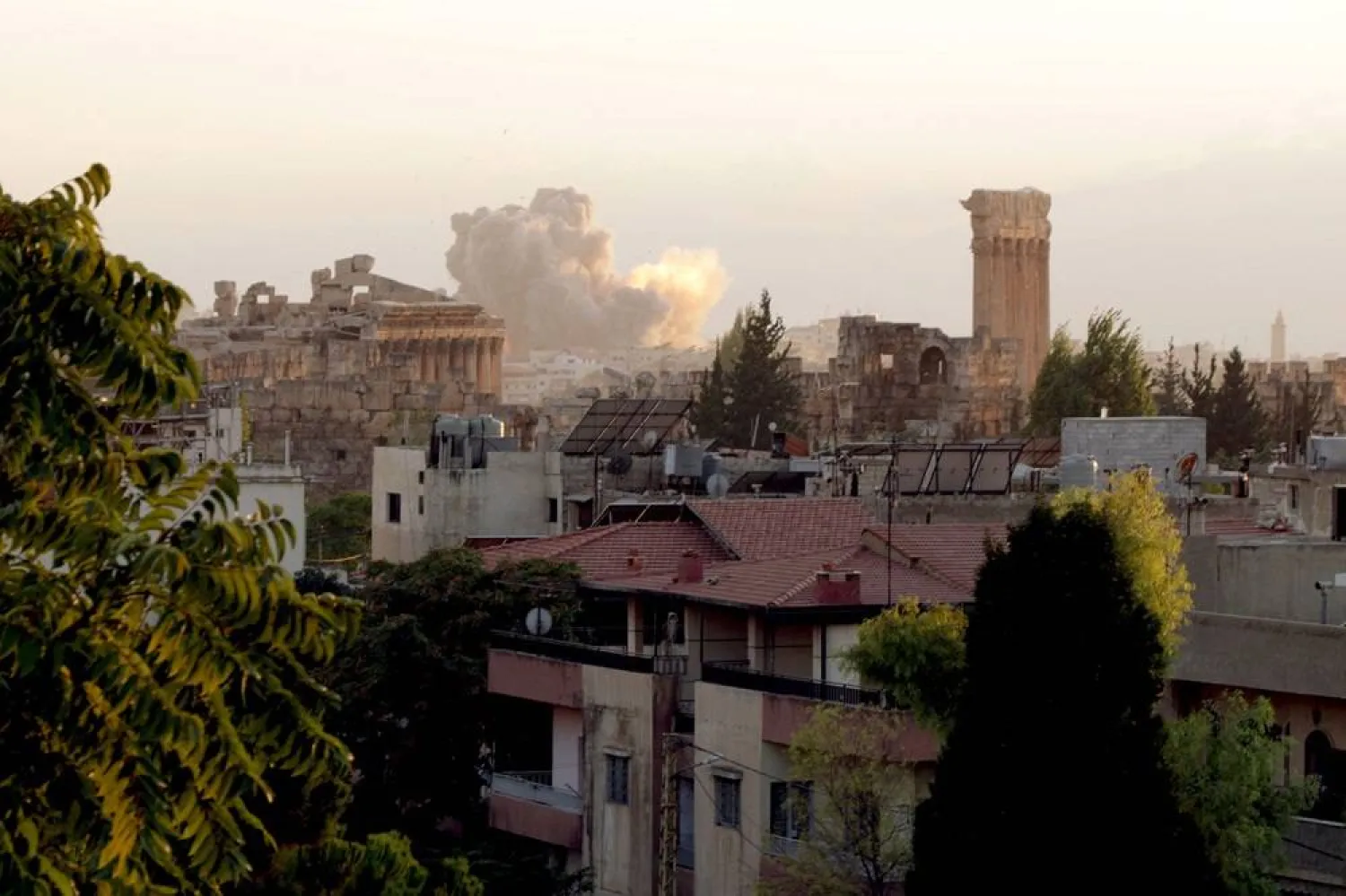 Smoke billows from the site of an Israeli airstrike on the Lebanese city of Baalbek in the Bekaa valley on September 23, 2024, behind the ancient Roman ruins and the six columns that remain standing at the Temple of Jupiter. (AFP) 
