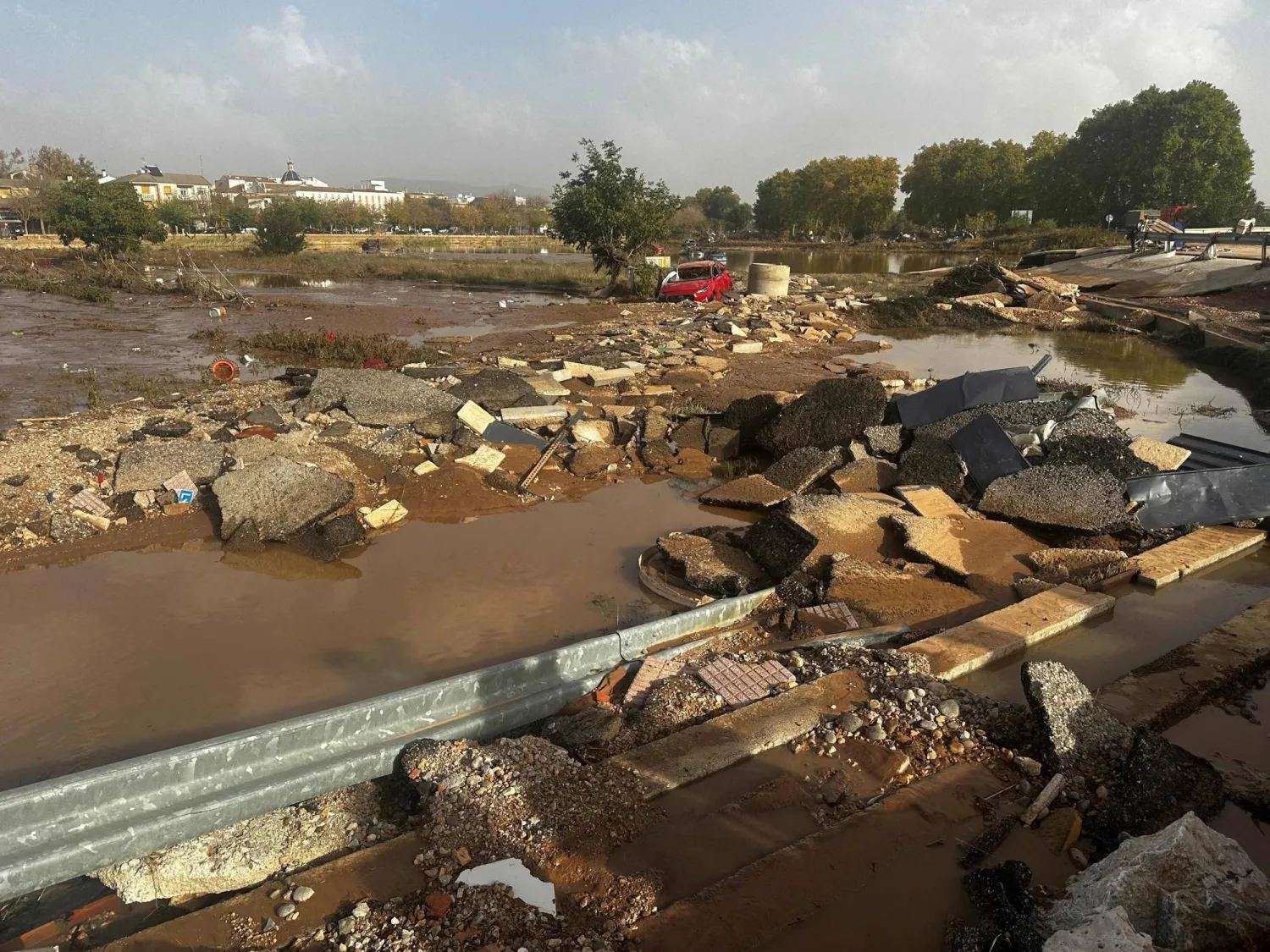 A picture taken on October 31, 2024 shows a road destroyed and flooded fields after flash floods in Utiel, in the region of Valencia, eastern Spain. (Photo by Wafaa ESSALHI / AFP)