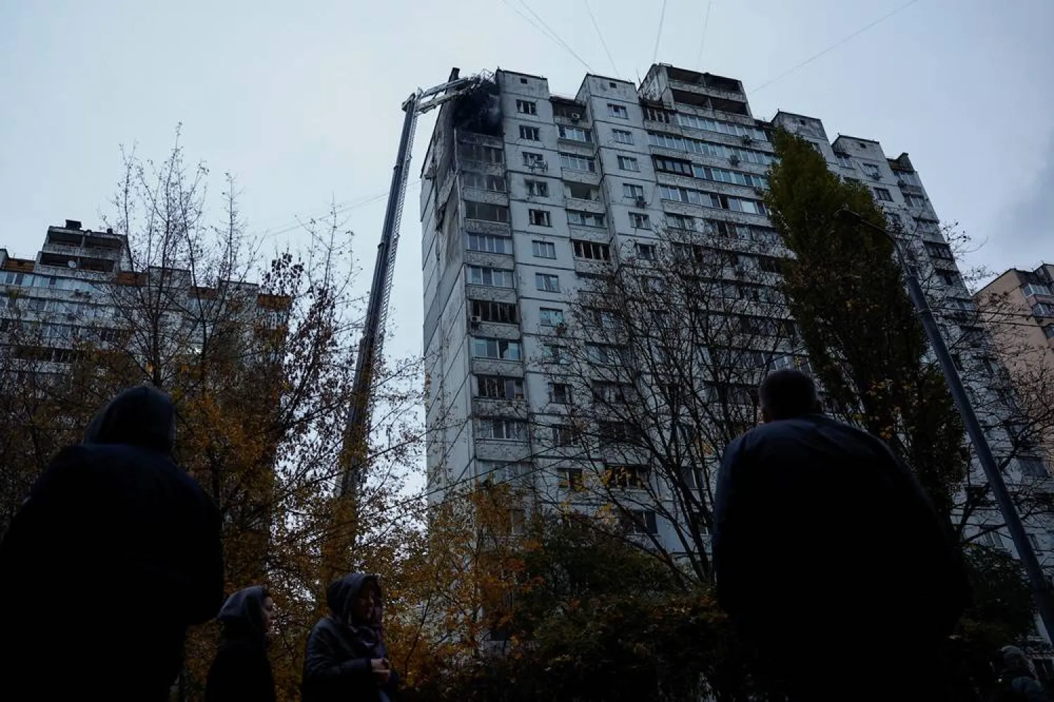  Residents stand in front of an apartment building damaged by a Russian drone strike, amid Russia's attack on Ukraine, in Kyiv, Ukraine November 2, 2024. (Reuters)