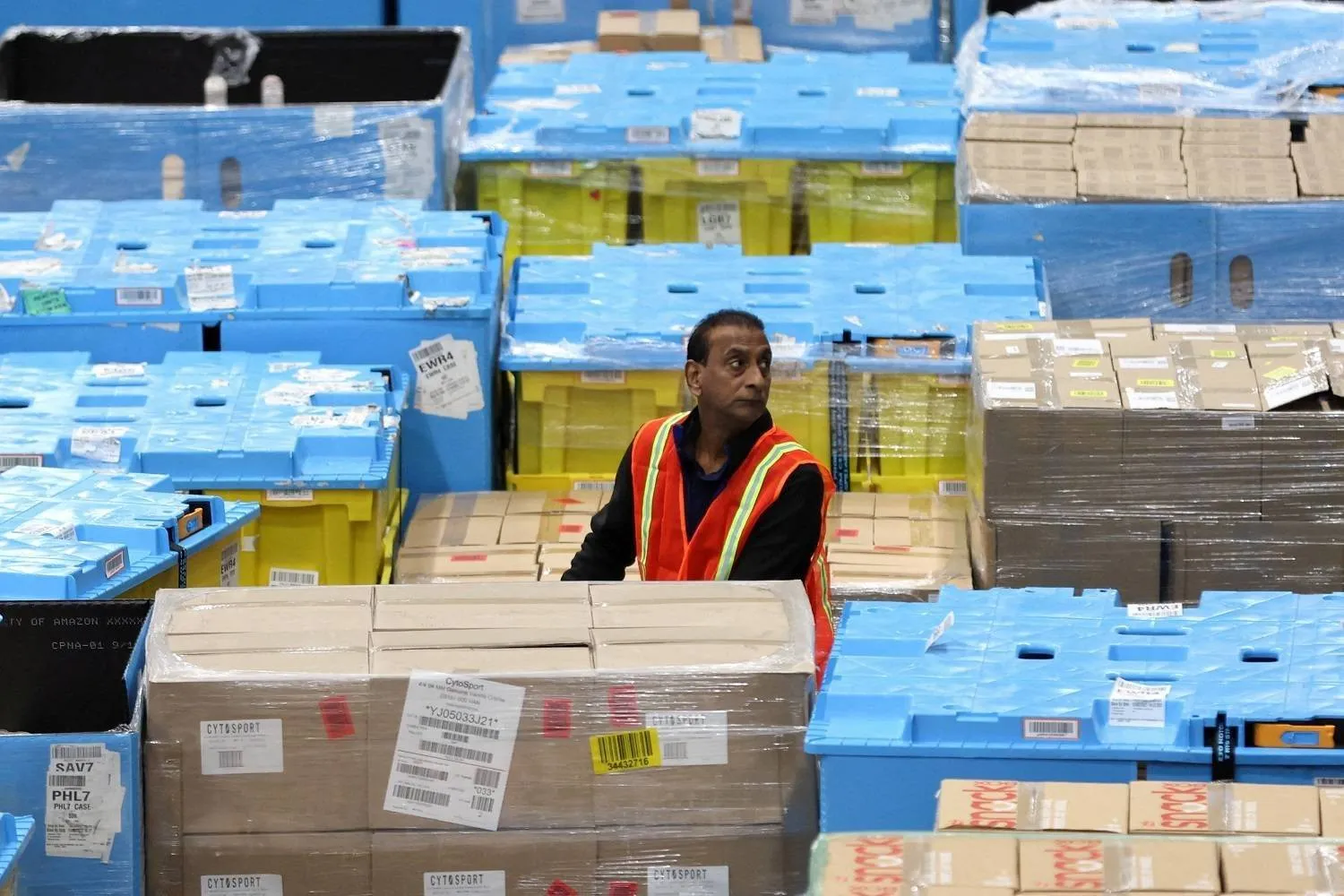 A worker transports items during Cyber Monday at the Amazon fulfillment center in Robbinsville Township in New Jersey, US (Reuters/File)