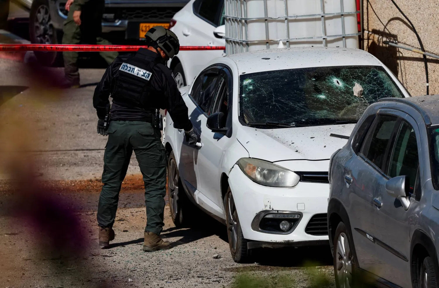 A member of the Israeli security forces works next to a damaged car at the site of a drone attack, amid ongoing hostilities between Hezbollah and Israeli forces, in Karmiel, northern Israel October 27, 2024. REUTERS/Gonzalo Fuentes