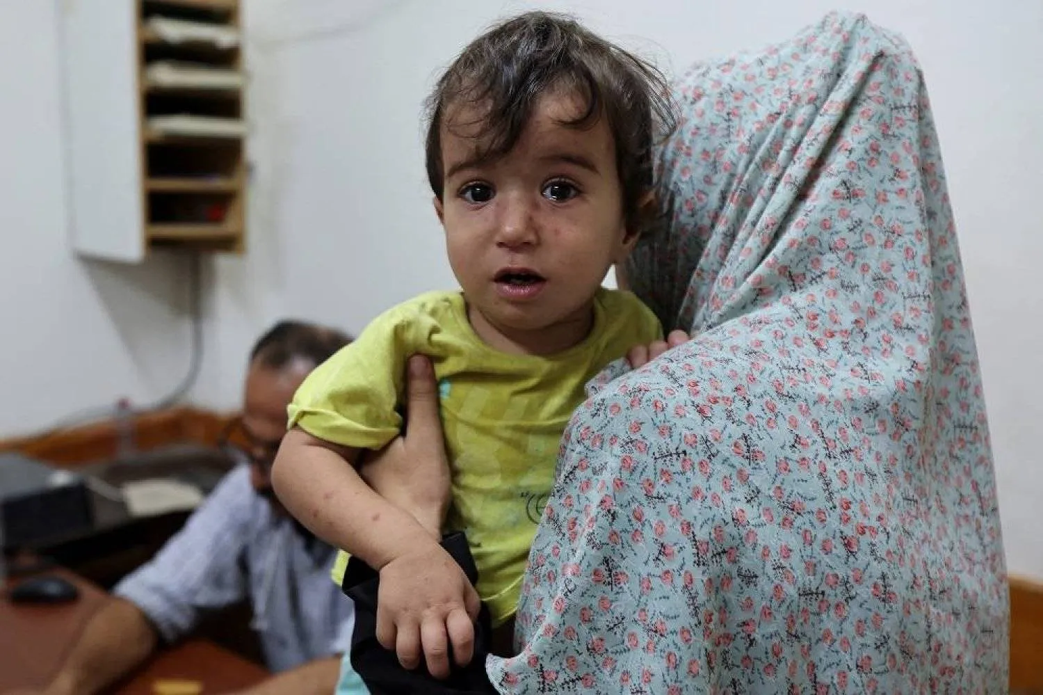 A Palestinian child looks on while being examined by a doctor at Al-Aqsa Martyrs Hospital, amid fears over the spread of polio after the first case was reported by the Ministry of health, as the conflict between Israel and Hamas continues, in Deir al-Balah in the central Gaza Strip, August 18, 2024. (Reuters)
