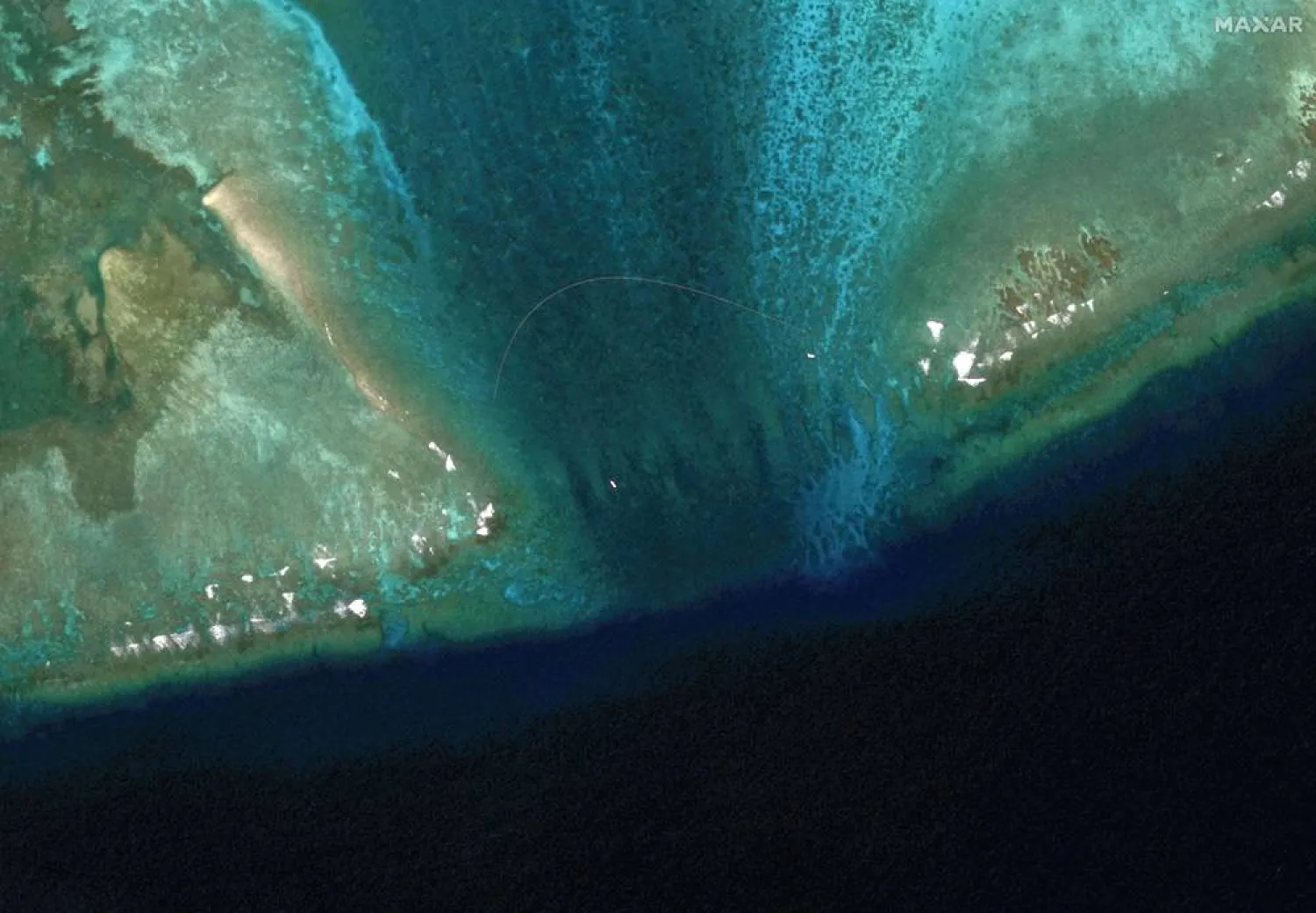 A floating barrier is placed at the entrance of Scarborough Shoal in the South China Sea, February 22, 2024. (Maxar Technologies/Handout via Reuters) 