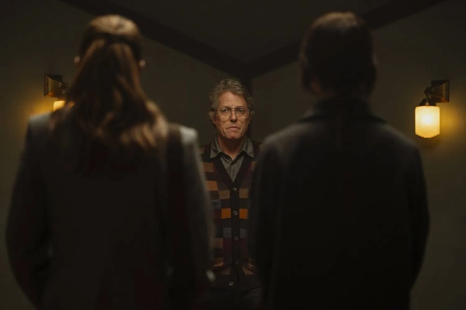  This image released by A24 shows, from left, Chloe East, Hugh Grant, and Sophie Thatcher in a scene from "Heretic." (Kimberley French/A24 via AP) 