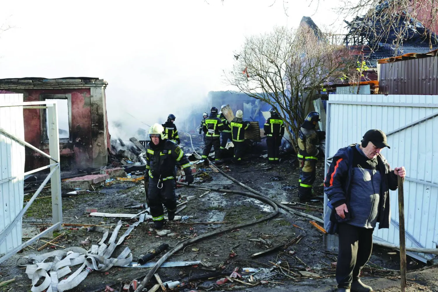 Rescuers clean debris in the courtyard of a house following a drone attack in the village of Stanovoye, Moscow region, on November 10, 2024. (Photo by TATYANA MAKEYEVA / AFP)
