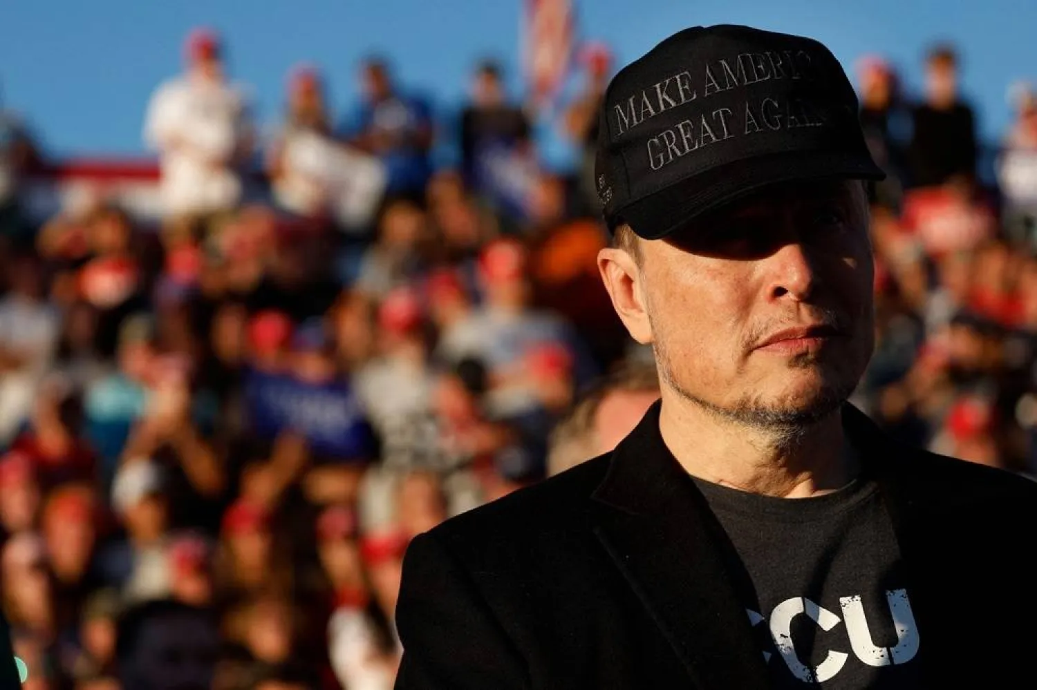 Tesla and SpaceX CEO Elon Musk wears a black "Make America Great Again" ball cap while attending a campaign rally with Republican presidential nominee, former President Donald Trump at the Butler Farm Show fairgrounds on October 05, 2024 in Butler, Pennsylvania. (AFP)
