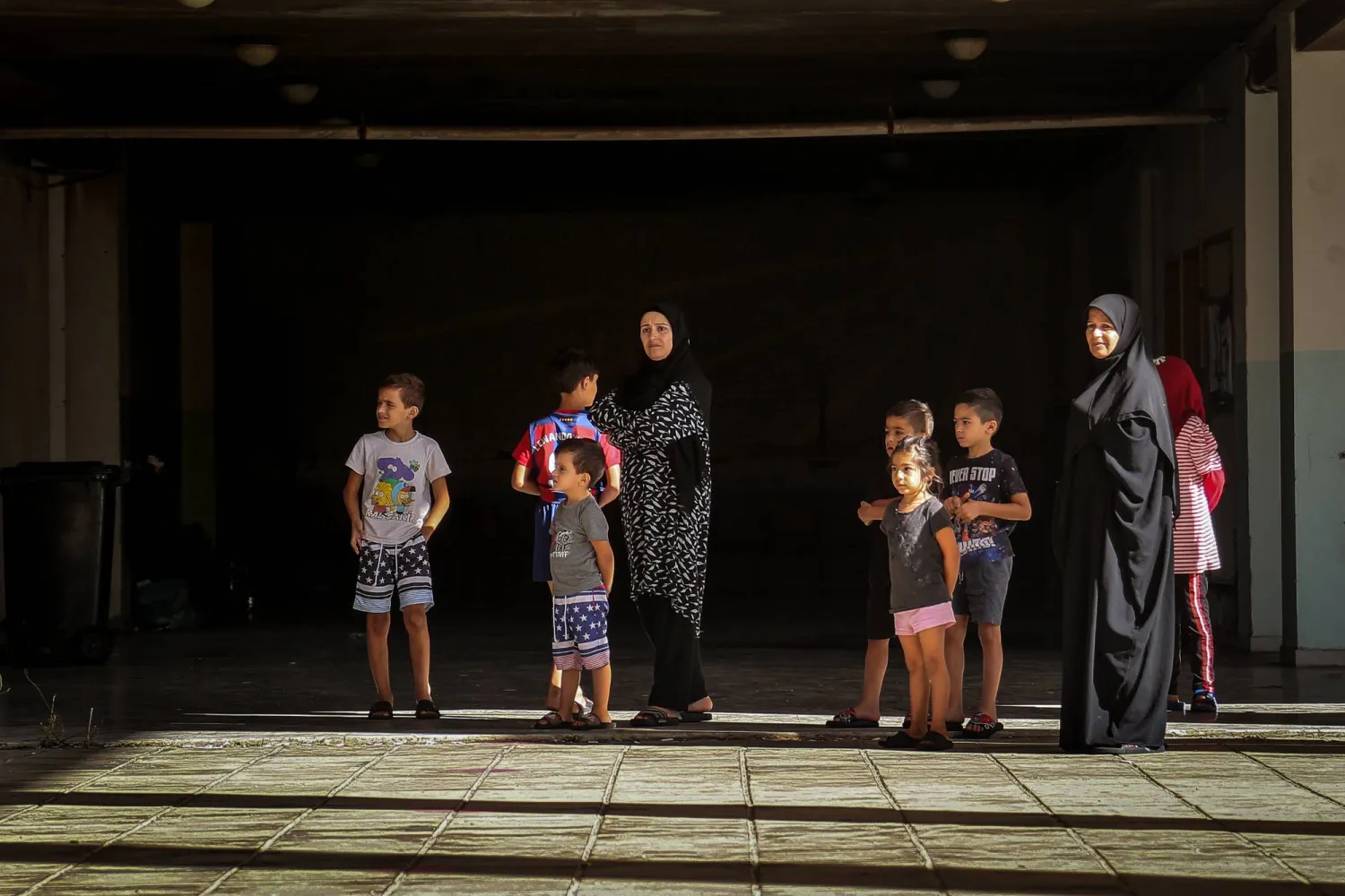 FILED - 03 October 2024, Lebanon, Beirut: Lebanese women and their children, who fled south Lebanon, stand at a local school sheltering displaced people in Beirut. Photo: Marwan Naamani/dpa