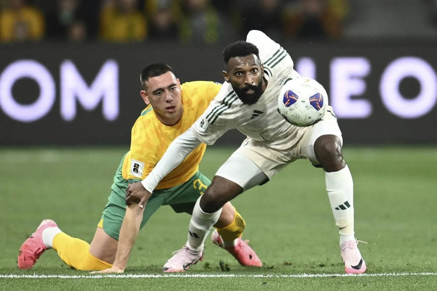 Australia’s Lewis Miller, left, and Saudi Arabia’s Feras Albrikan compete for the ball during the 2026 World Cup qualifier between Australia and Saudi Arabia in Melbourne, Australia, Thursday, Nov. 14, 2024. (Joel Carrett/AAP Image via AP)