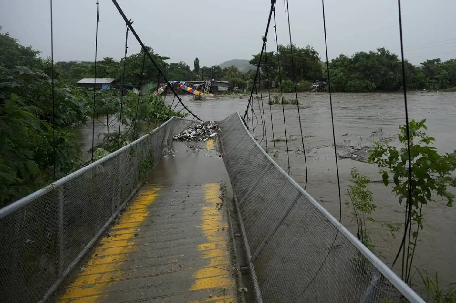  A pedestrian bridge collapsed due to flooding caused by rains brought on by Tropical Storm Sara in San Pedro Sula, Honduras Saturday, Nov. 16, 2024. (AP)