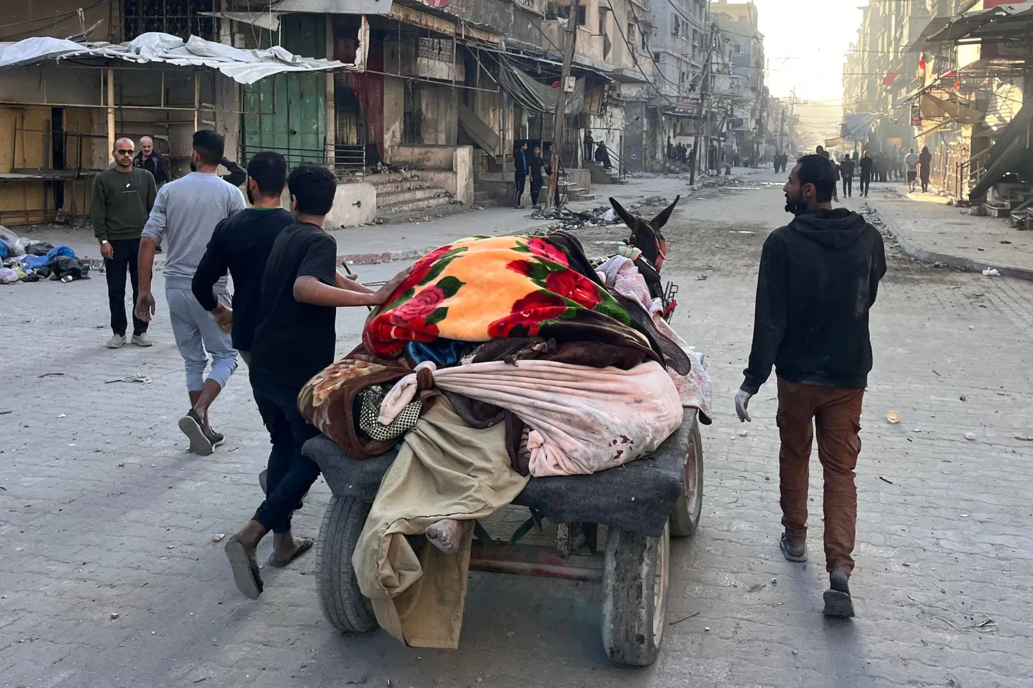 People transport bodies of victims on a donkey-pulled kart, following an overnight Israeli strike in Beit Lahya in the northern Gaza Strip on November 17, 2024. (Photo by AFP)