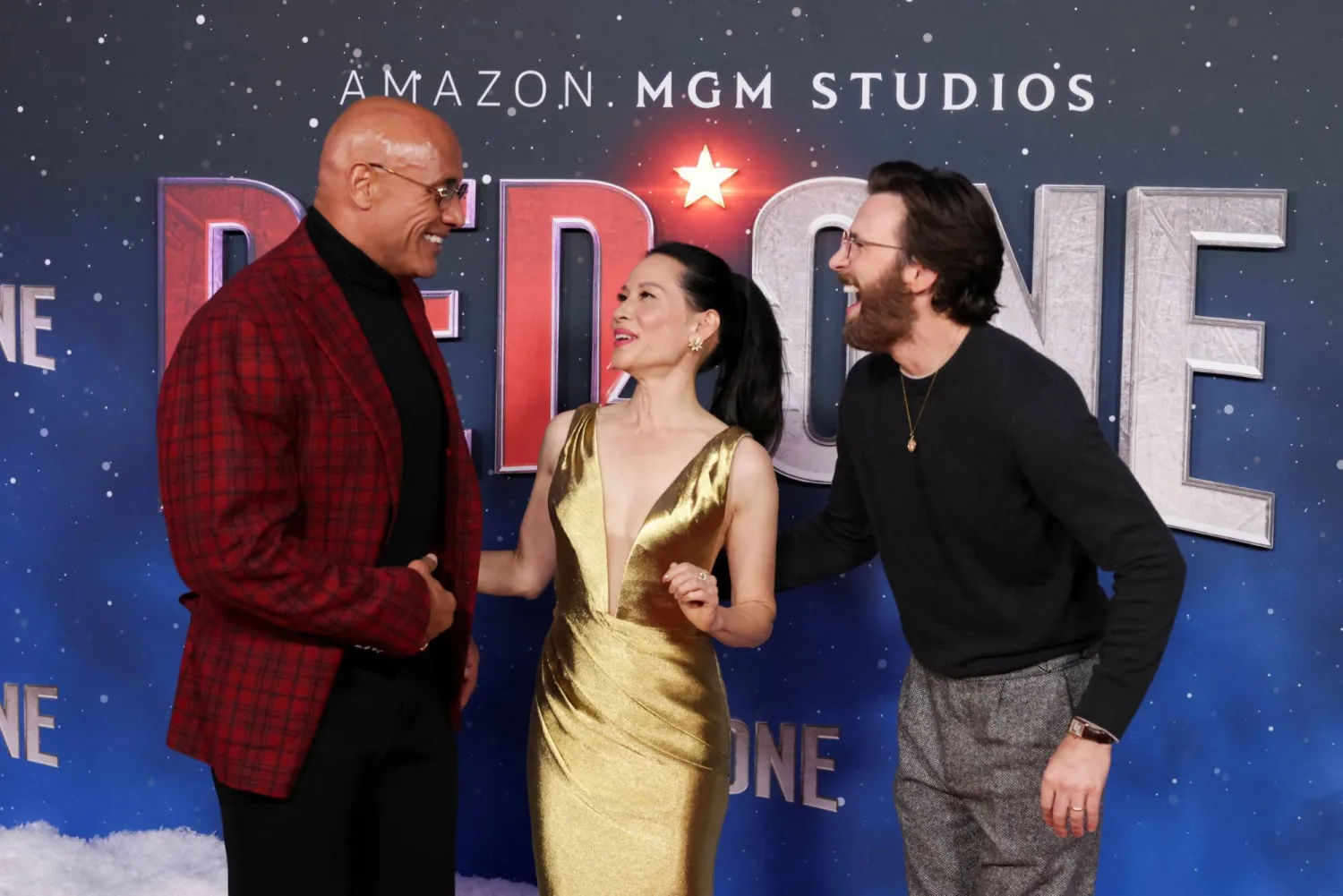 Dwayne Johnson, Lucy Liu, and Chris Evans laugh at the premiere of the holiday film "Red One" in New York City, New York US, November 11, 2024. REUTERS/Kent J Edwards
