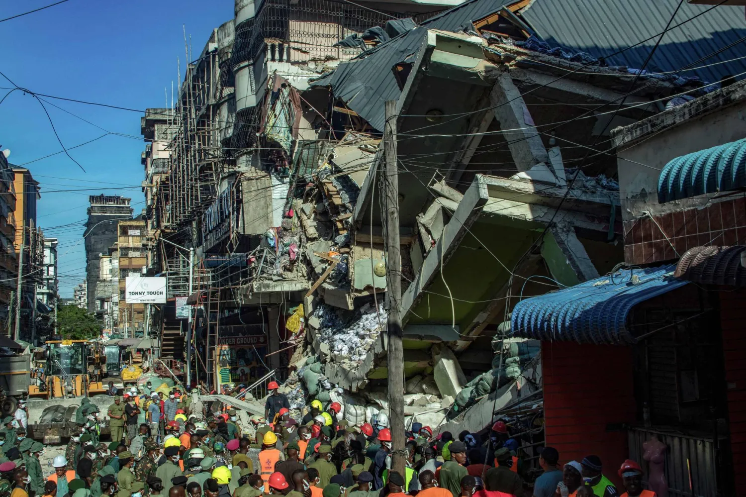 Emergency crews and first responders gather for rescue operations at the site of a collapsed four-story building in Dar es Salaam on November 16, 2024. (Photo by Gidulaus Amosi / AFP)