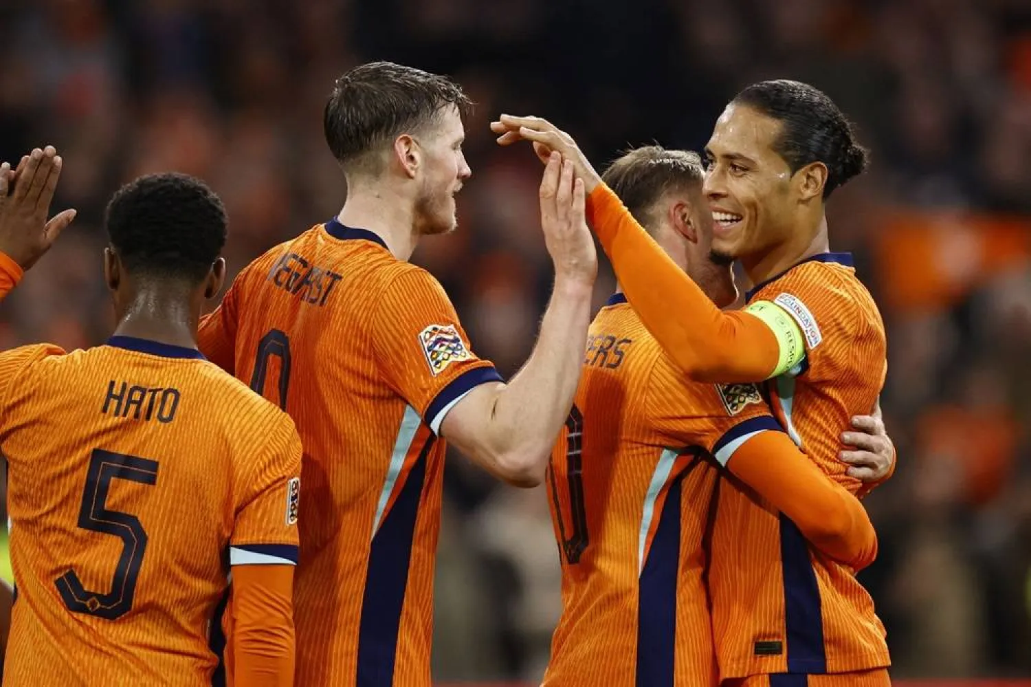 Netherlands' Teun Koopmeiners (2ndR) is congratulated by teammates Netherlands' defender #04 Virgil van Dijk (R) and Netherlands' forward #09 Wout Weghorst (2ndL) after scoring a goal during the UEFA Nations League football match between the Netherlands and Hungary at the Johan Cruyff ArenA on November 16, 2024 in Amsterdam. (AFP) 