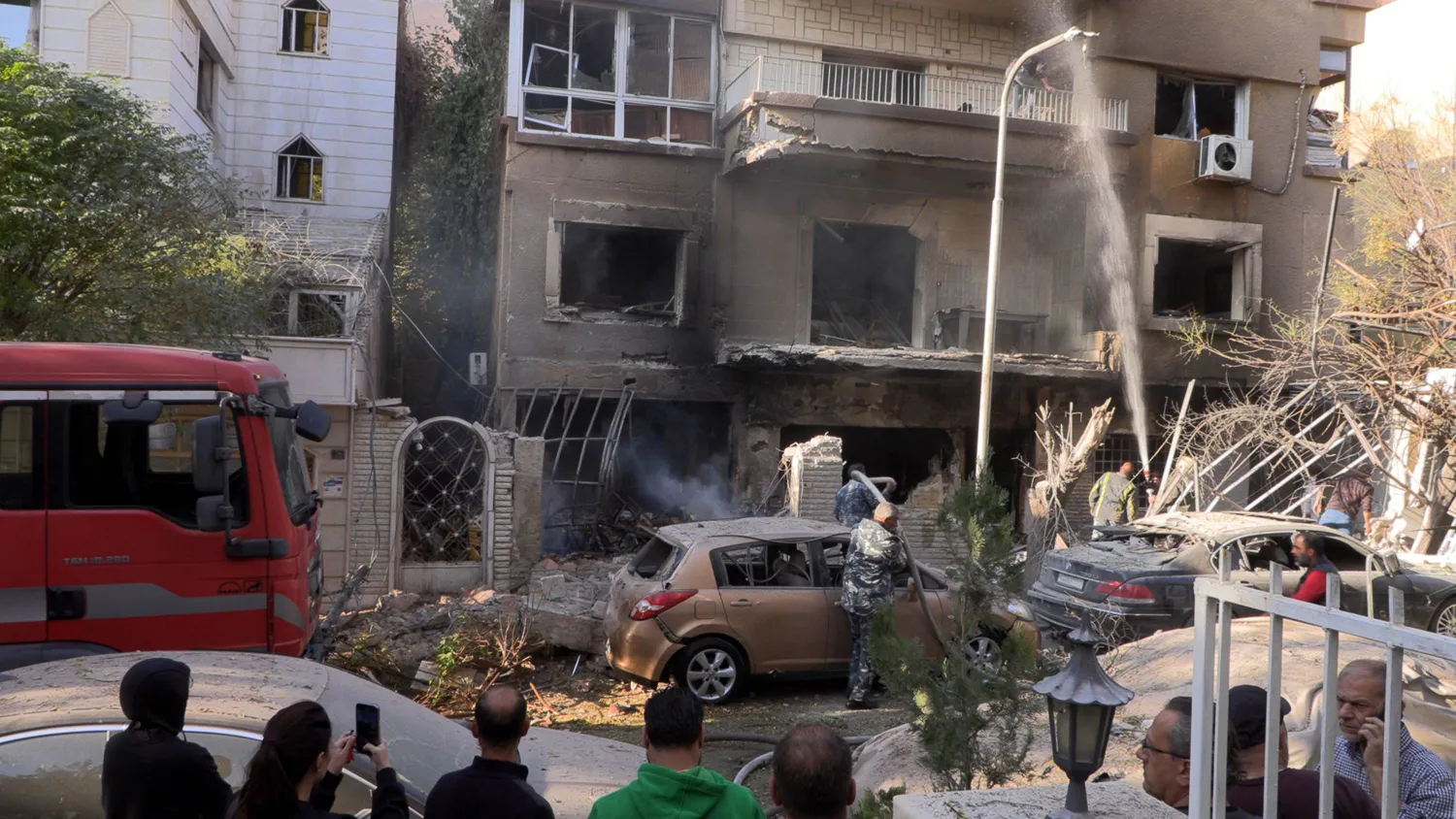 Syrian security forces and civilians inspect the scene of an airstrike in the Al-Mazzeh neighborhood of Damascus, Syria, 14 November 2024. EPA/STRINGER