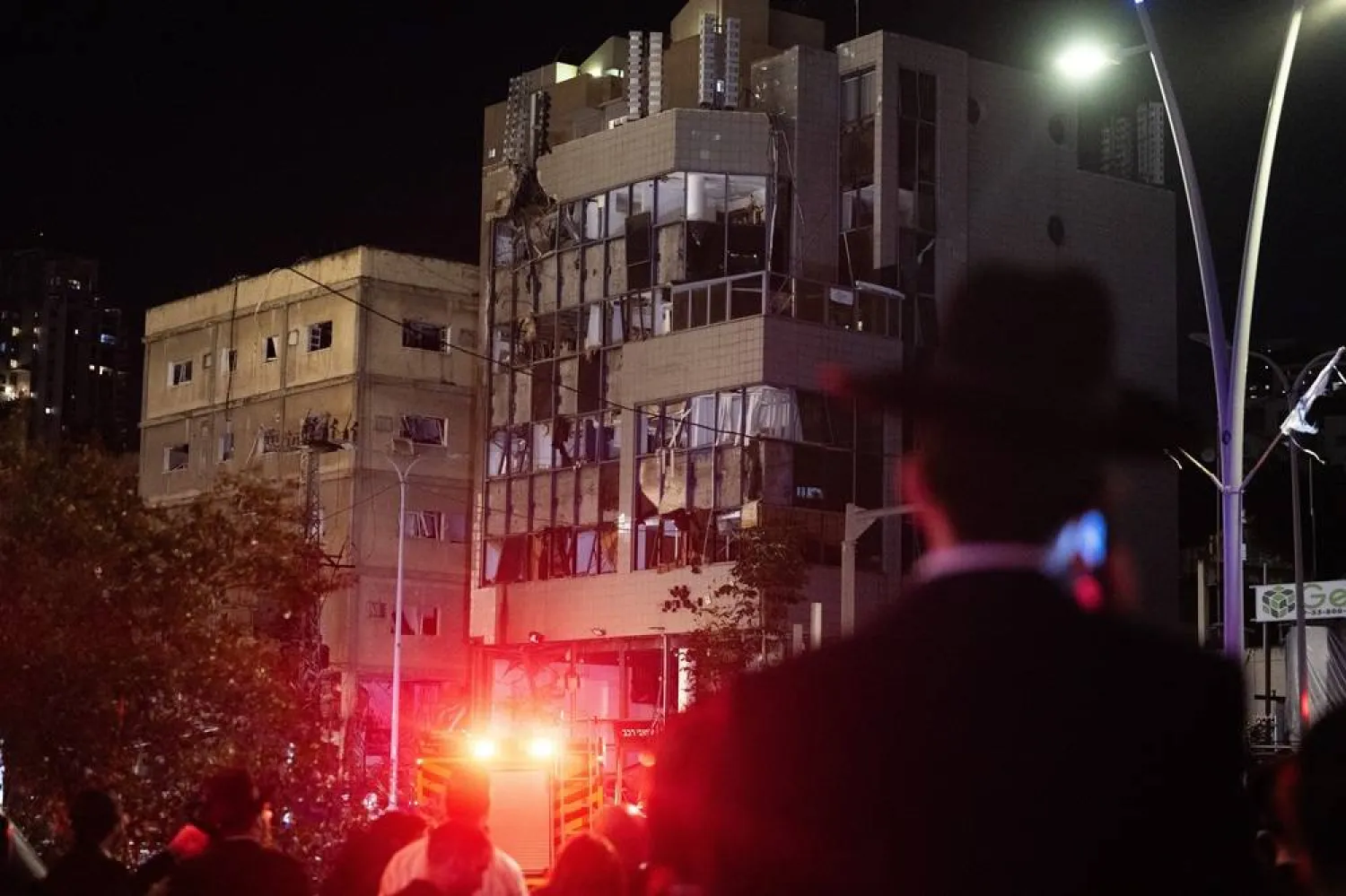 Israeli security inspect damages caused by debris from an intercepted missile, in Ramat Gan, Tel Aviv, Israel, 18 November 2024. (EPA)