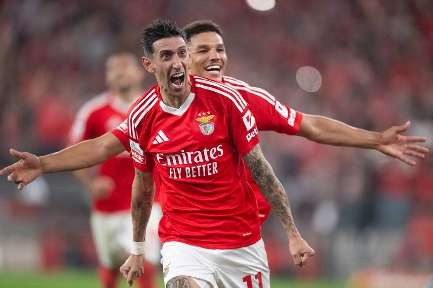 Benfica's Argentine forward #11 Angel Di Maria (front) celebrates with teammate Benfica's Danish defender #6 Alexander Bah after converting a penalty to score their fourth goal during the Portuguese League football match between SL Benfica and FC Porto at at the Luz stadium in Lisbon, on November 10, 2024. (AFP)