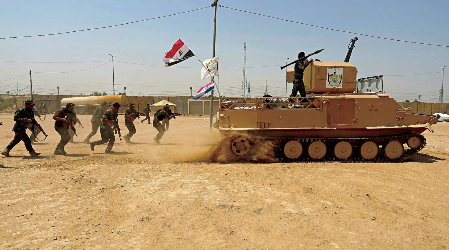  تمرين عسكري لاثنين من فصائل «الحشد الشعبي» (أ.ب)