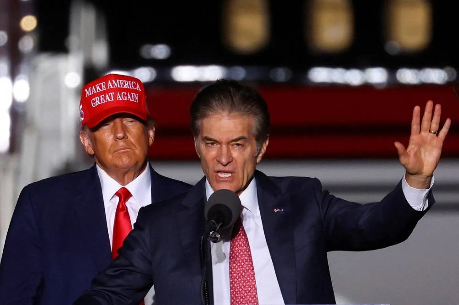 Former US President Donald Trump looks on as Pennsylvania Republican US Senate candidate Dr. Mehmet Oz speaks at a pre-election rally to support Republican candidates in Latrobe, Pennsylvania, US, November 5, 2022. (Reuters) 