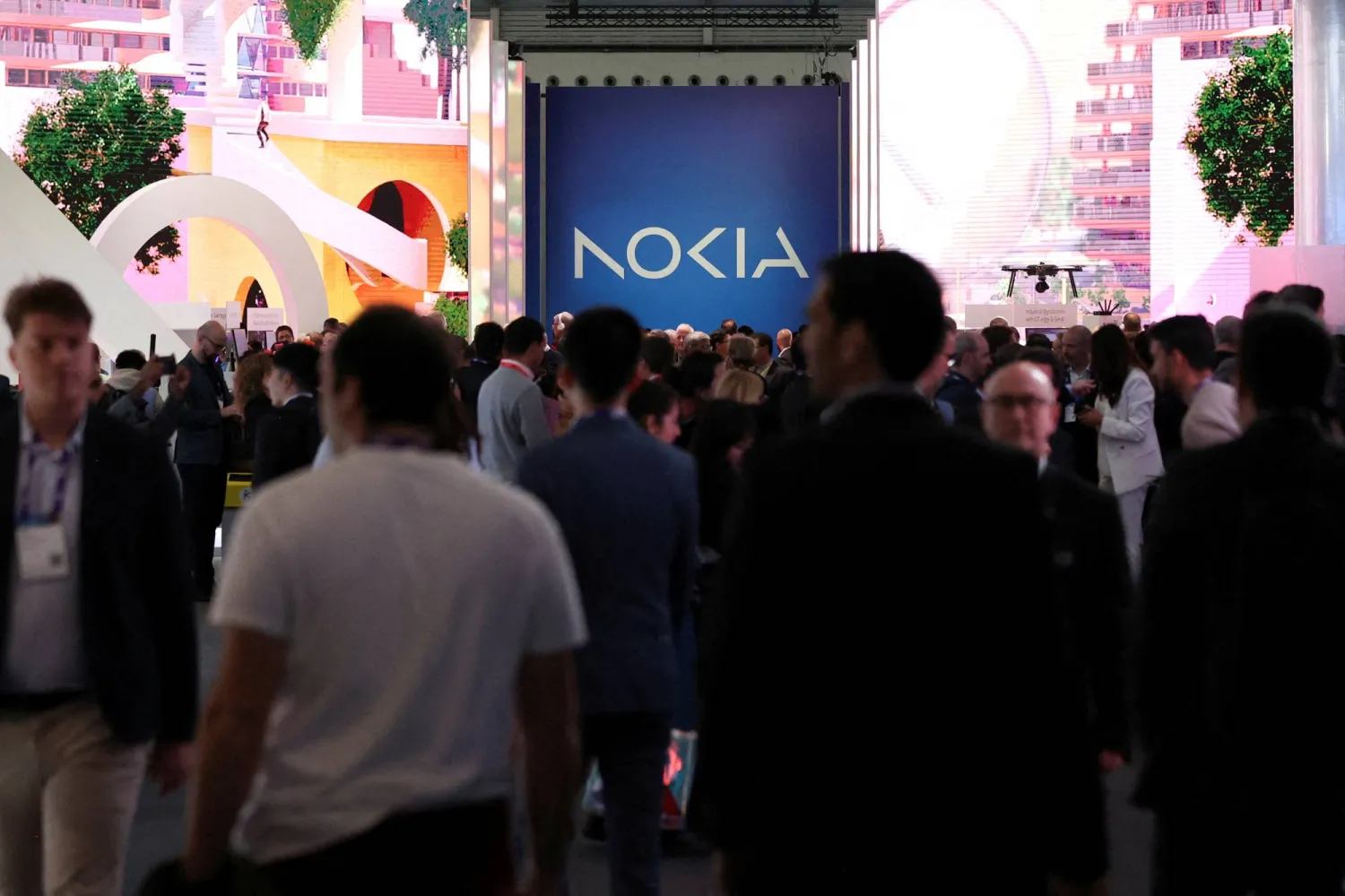FILE PHOTO: People walk next to the Nokia stand as they attend the Mobile World Congress (MWC) in Barcelona, Spain February 27, 2024. REUTERS/Bruna Casas/File Photo/File Photo