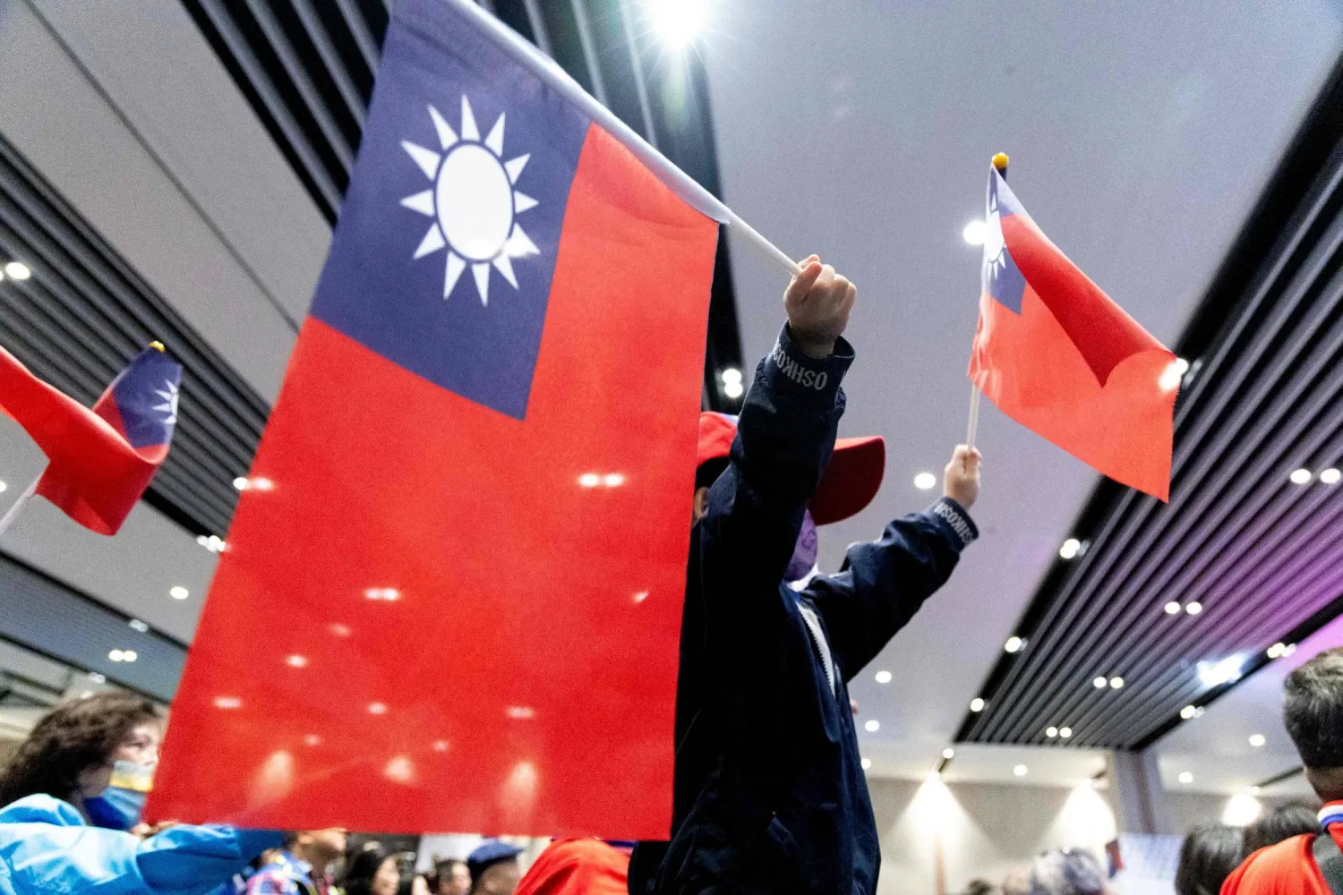 Participants wave Taiwanese flags during the Kuomintang (KMT) National Congress in Taoyuan on November 24, 2024. (Photo by Yu Chien Huang / AFP)
