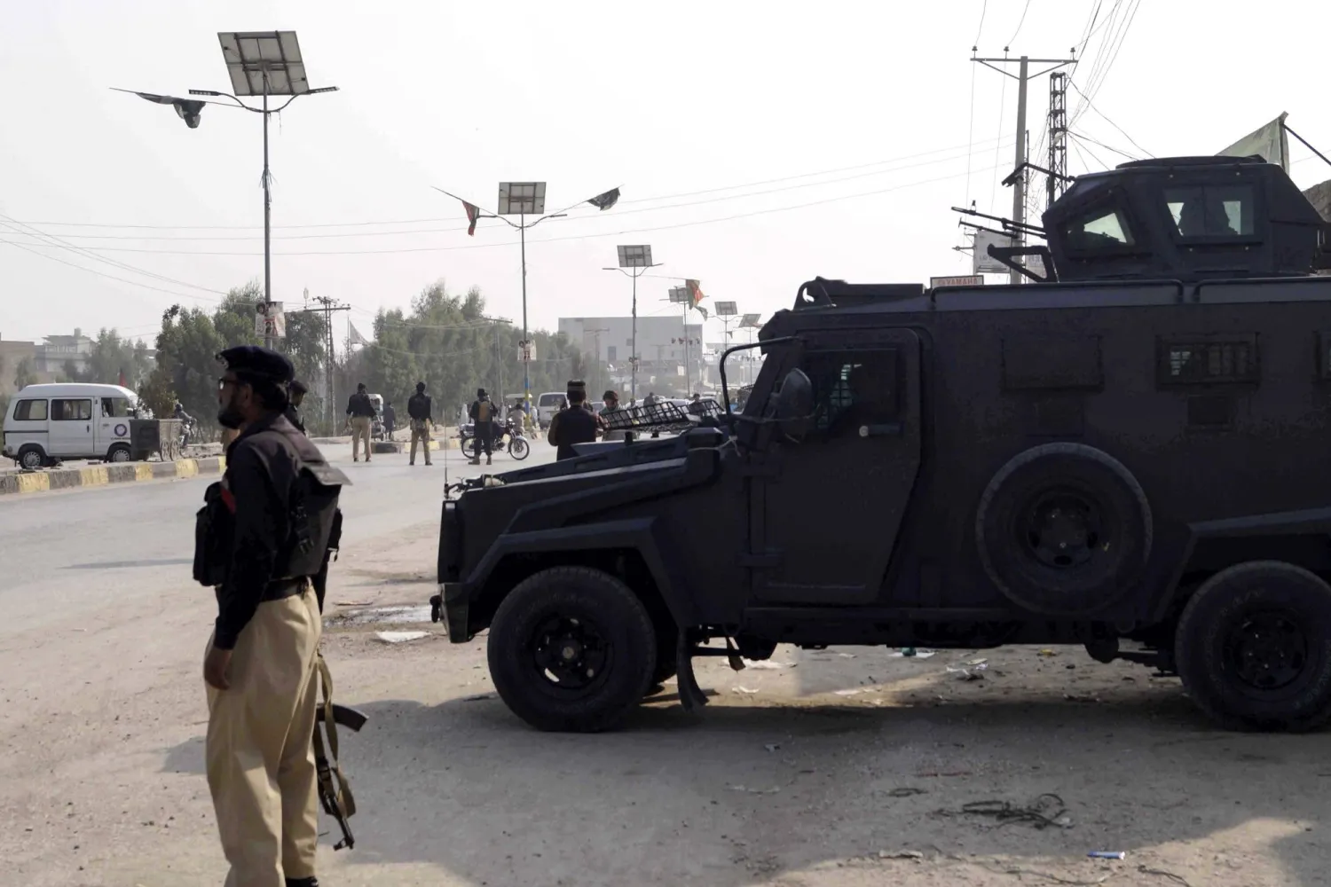 Police officers stand guard near their vehicles during a protest by Pakistani Shiite Muslims against an attack on passenger vehicles in Kurram, in Dera Ismail Khan District, Khyber Pakhtunkhwa province, Pakistan, 22 November 2024. EPA/SAOOD REHMAN