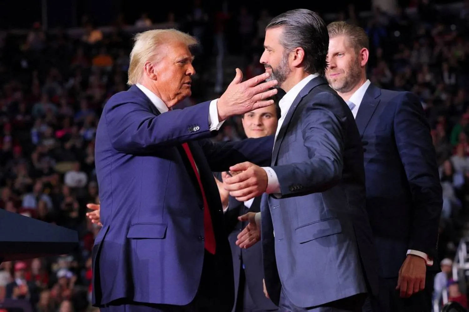 Republican presidential nominee and former US President Donald Trump approaches to embrace Donald Trump Jr. at his campaign rally, at PPG Paints Arena in Pittsburgh, Pennsylvania, US, November 4, 2024. (Reuters)