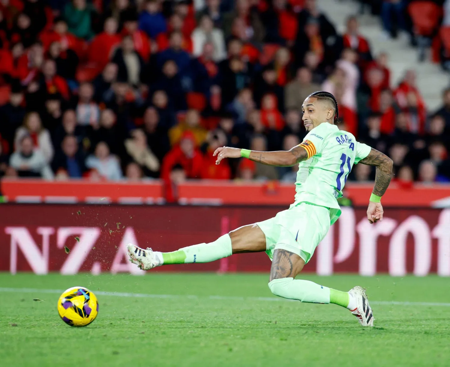 Barcelona's Brazilian forward #11 Raphinha kicks the ball during the Spanish league football match between RCD Mallorca and FC Barcelona at the Mallorca Son Moix stadium in Palma de Mallorca on December 3, 2024. (Photo by JAIME REINA / AFP)