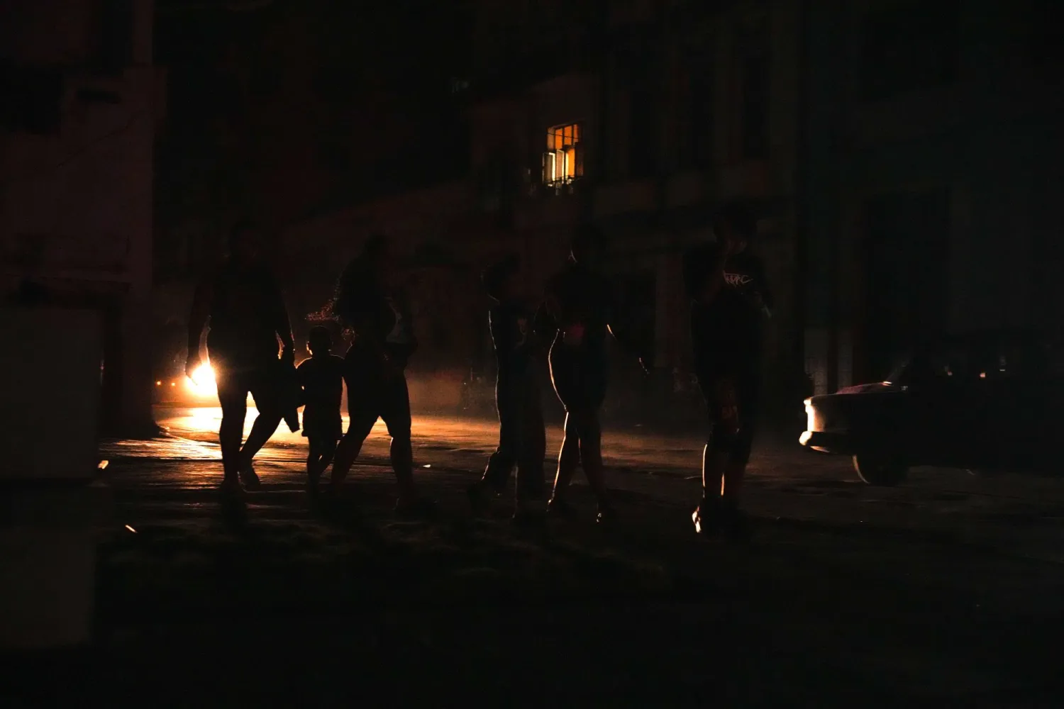 Residents walk on a street during a blackout following the failure of a major power plant in Havana, Cuba, Sunday, Oct. 20, 2024. (AP Photo/Ramon Espinosa)