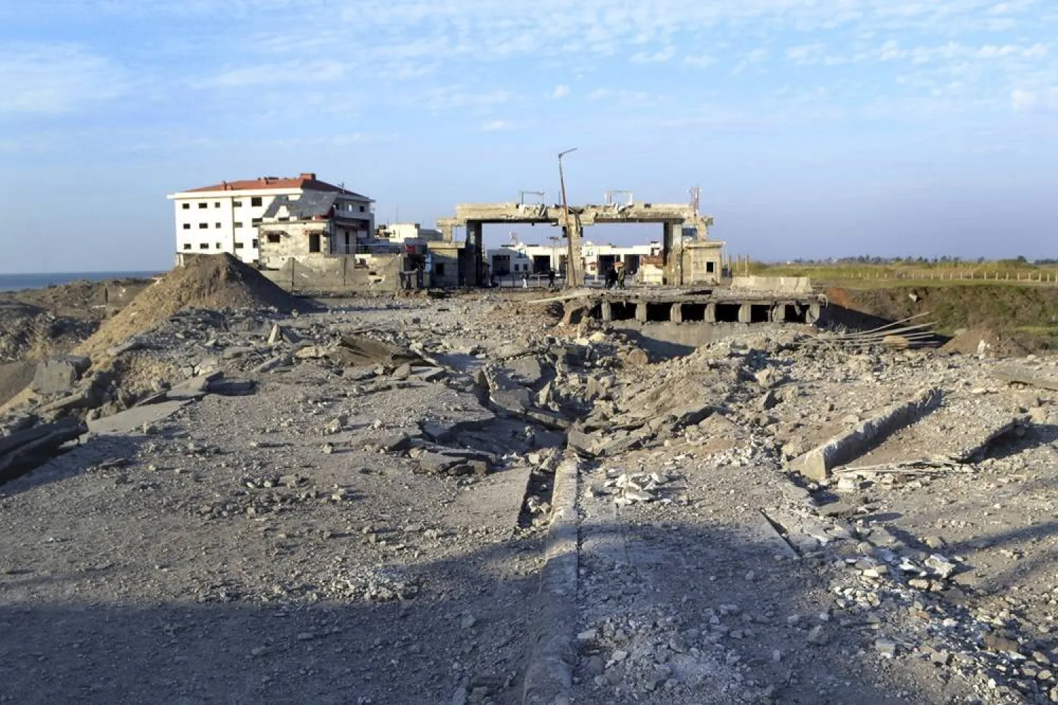  Destroyed roads are seen at the crossing border point between Lebanon and Syria which hit by an Israeli airstrike, in Arida, north Lebanon, Friday, Dec. 6, 2024. (AP)