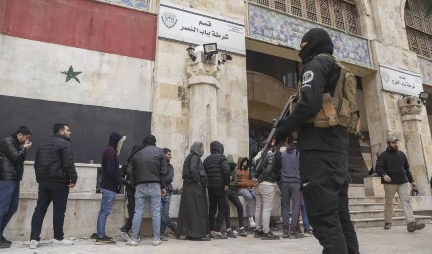 Defectors line-up to register their details with Syrian insurgents in Aleppo, Syria, Thursday Dec. 5, 2024. (AP Photo/Omar Albam)
