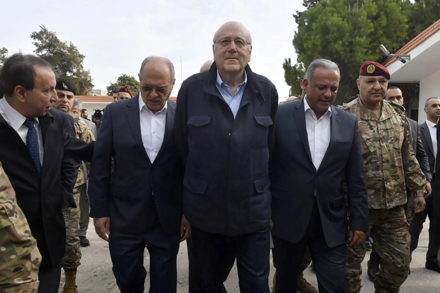 Lebanese caretaker Prime Minister Najib Mikati (C) arrives with cabinet ministers for a meeting at Benoit Barakat barracks in Tyre, southern Lebanon, 07 December 2024. (EPA) 