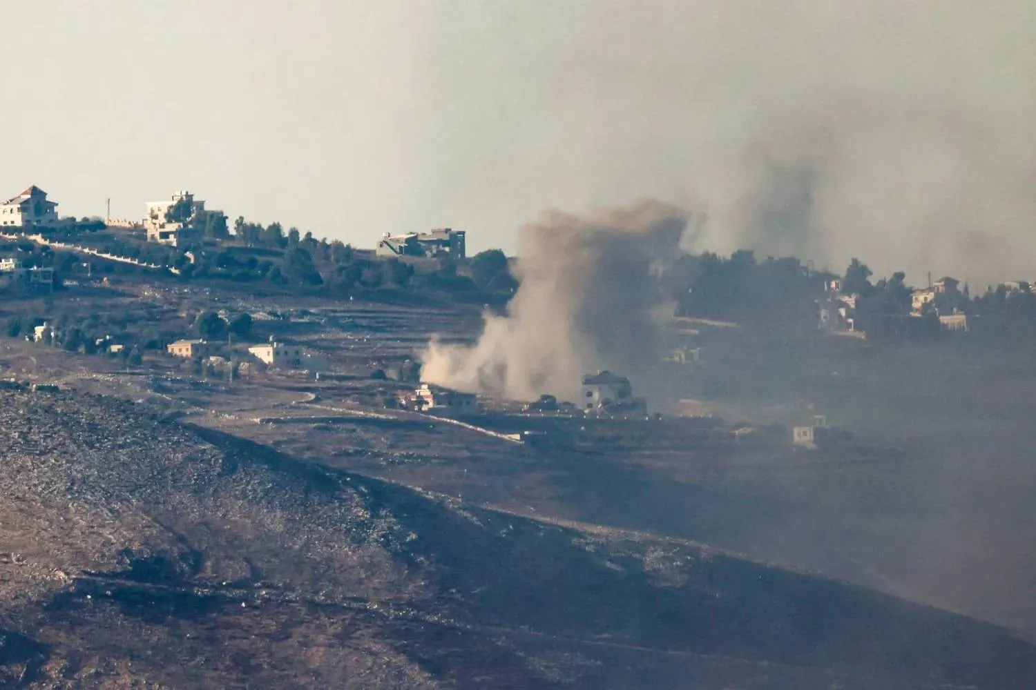 A picture taken from northern Israel along the border with southern Lebanon shows smoke billowing above south Lebanon during Israeli bombardment on October 4, 2024. (Photo by Jalaa MAREY / AFP)
