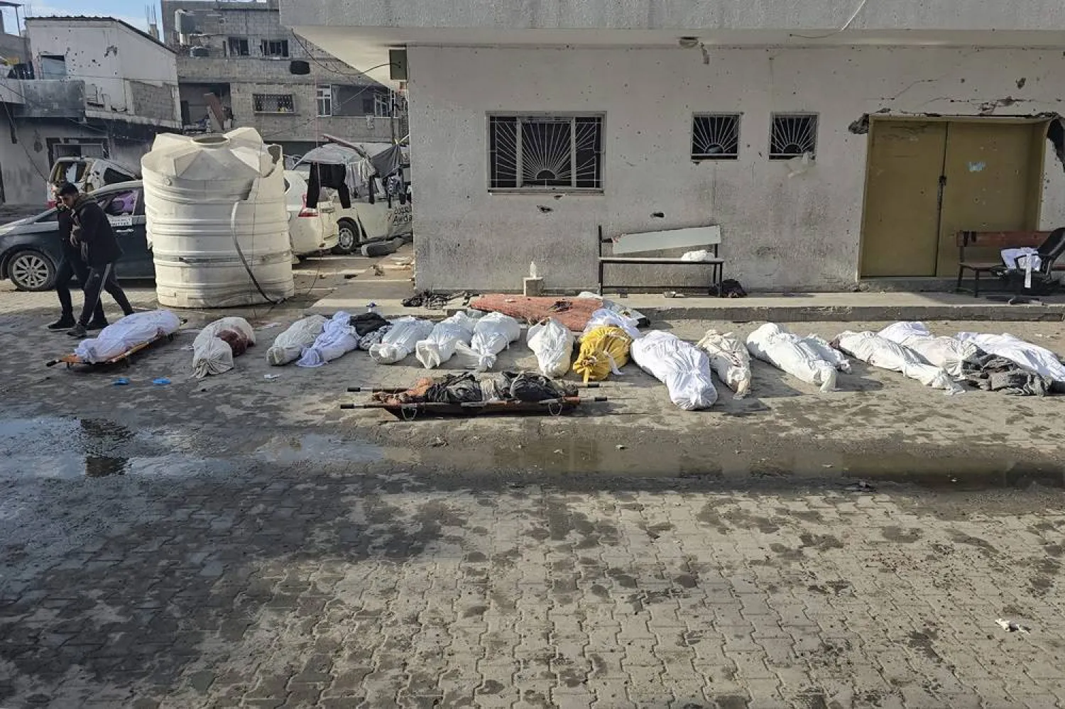  The bodies of victims lie in the courtyard of the Kamal Adwan hospital in Beit Lahiya in the northern Gaza Strip, following a reported Israeli strike that hit the medical complex on December 6, 2024, as the war between Israel and the Palestinian Hamas group continues. (AFP) 