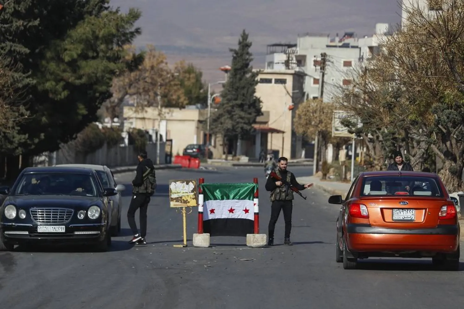  Syrian opposition fighters man a checkpoint in Damascus, Syria, Monday Dec. 9, 2024. (AP)