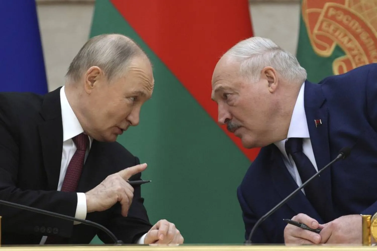  Russian President Vladimir Putin and Belarusian President Alexander Lukashenko talk during a signing ceremony following a meeting of the Supreme State Council of the Russia-Belarus Union State marking the 25th anniversary of the Union State Treaty in Minsk, Belarus, Friday, Dec. 6, 2024.(Gavriil Grigorov, Sputnik, Kremlin Pool Photo via AP) 