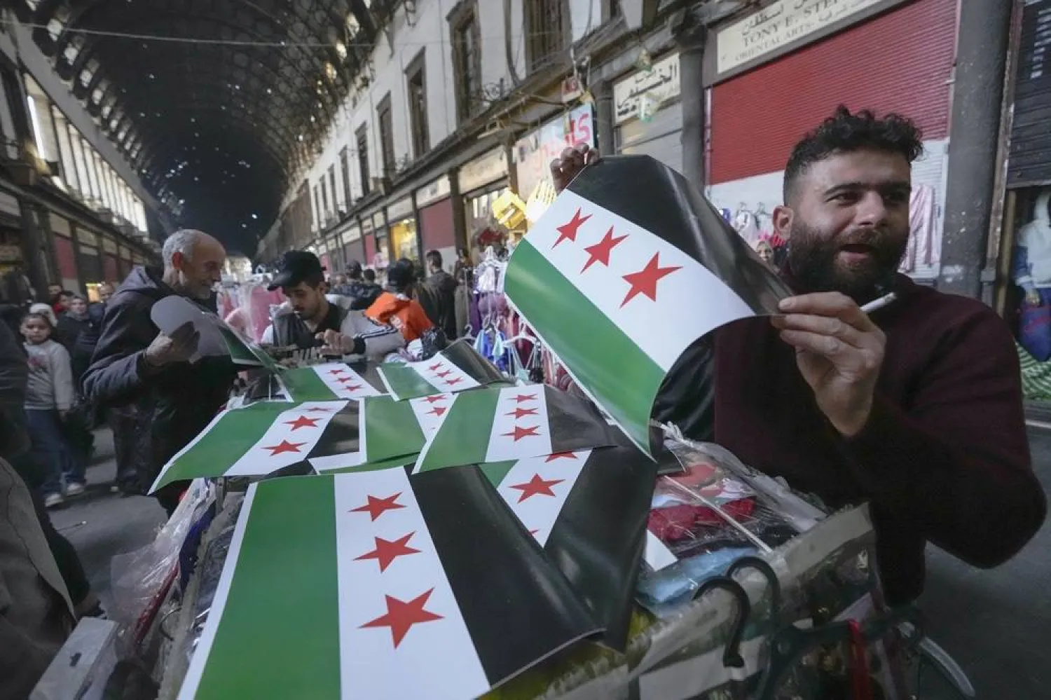  A man sells opposition flags at the Al-Hamidiyeh market inside the old walled city of Damascus, Syria, Tuesday, Dec. 10, 2024. (AP) 
