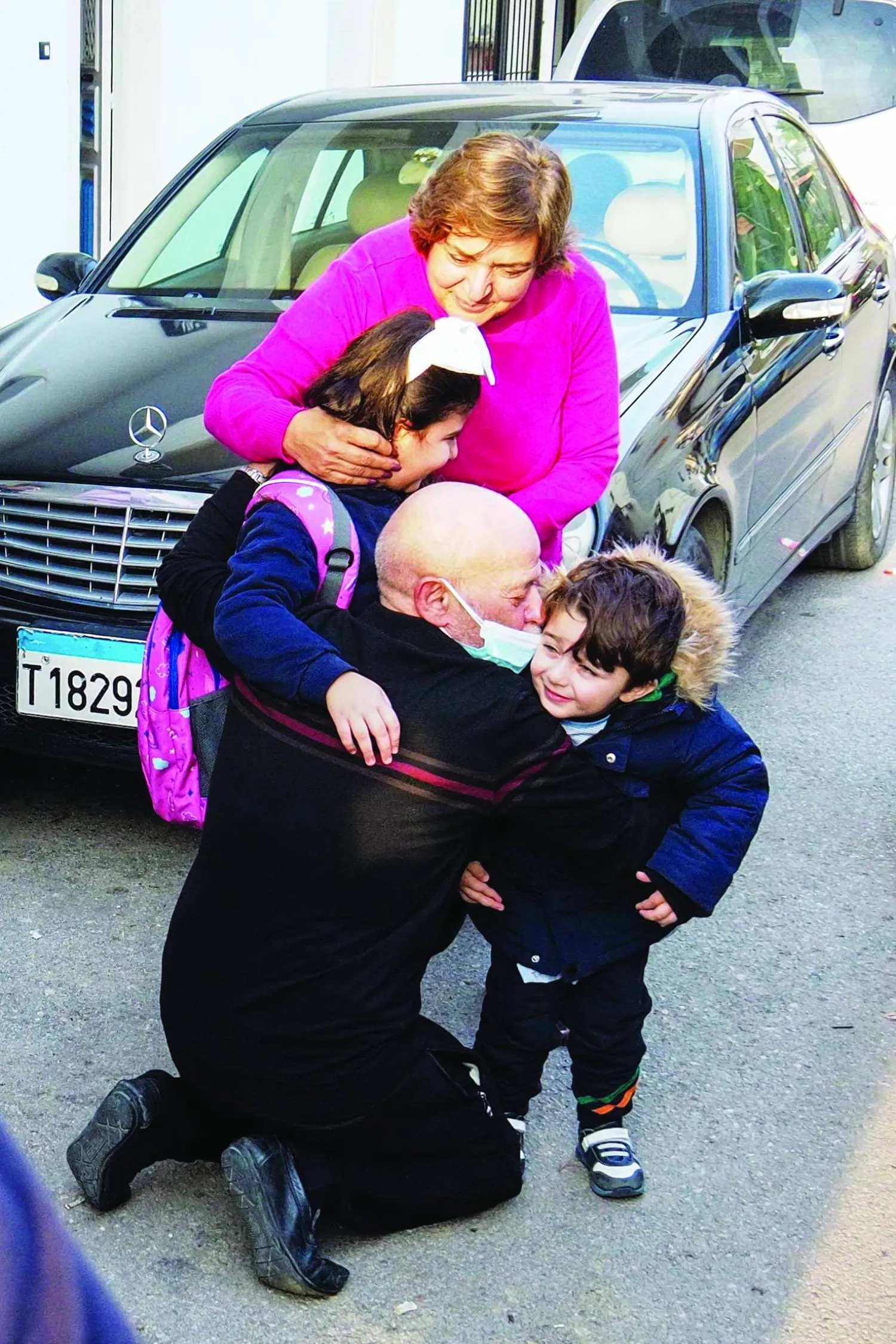 Suhail al-Hamwi (61) hugs his grandchildren in the coastal town of Chekka in northern Lebanon on December 9, 2024, after spending 33 years in a Syrian prison, following the ousting of Syria's President Bashar al-Bashar a day earlier. (Photo by Ibrahim CHALHOUB / AFP)