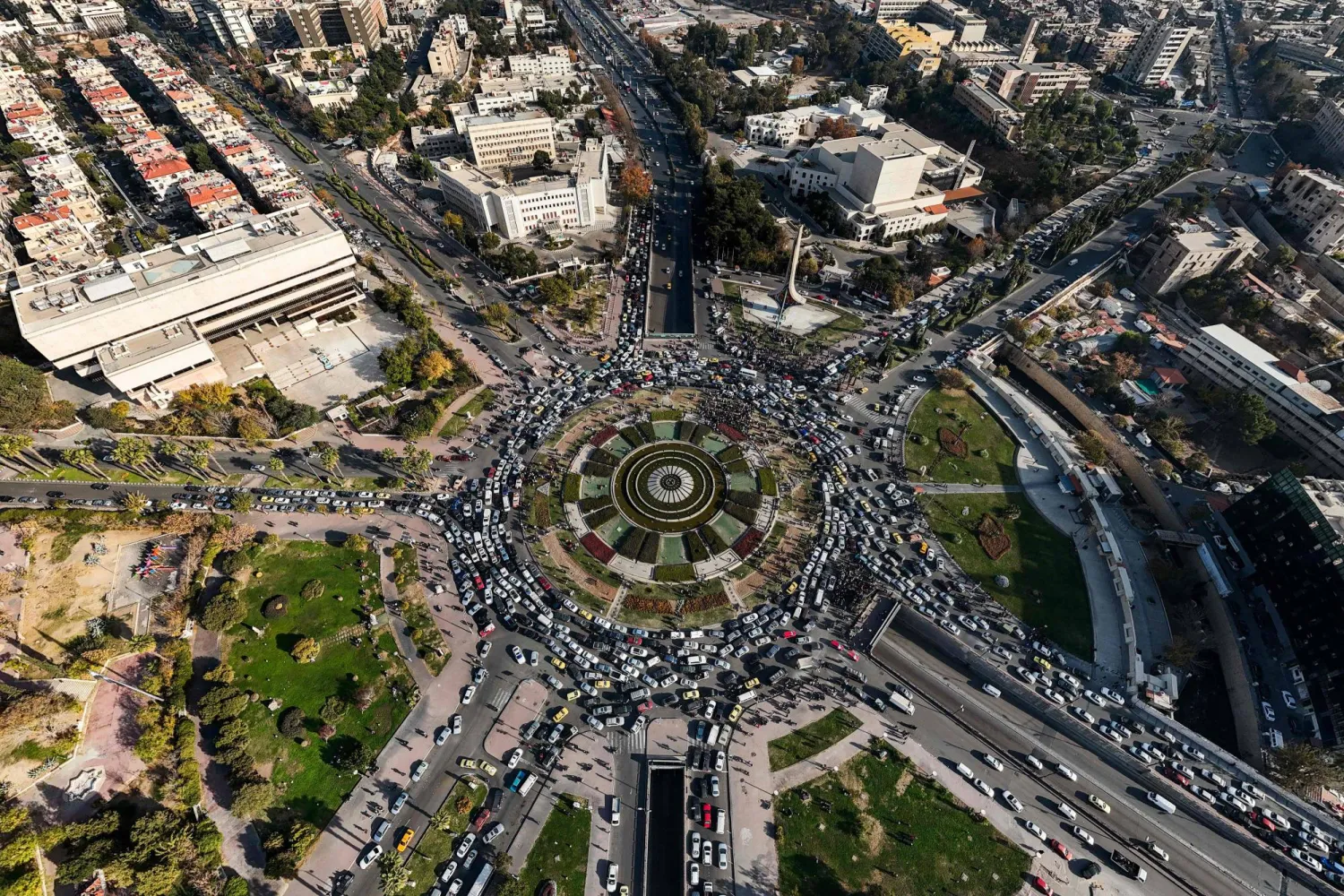 This aerial view shows traffic at Damascus' central Umayyad Square on December 10, 2024. (Photo by Bakr ALKASEM / AFP)